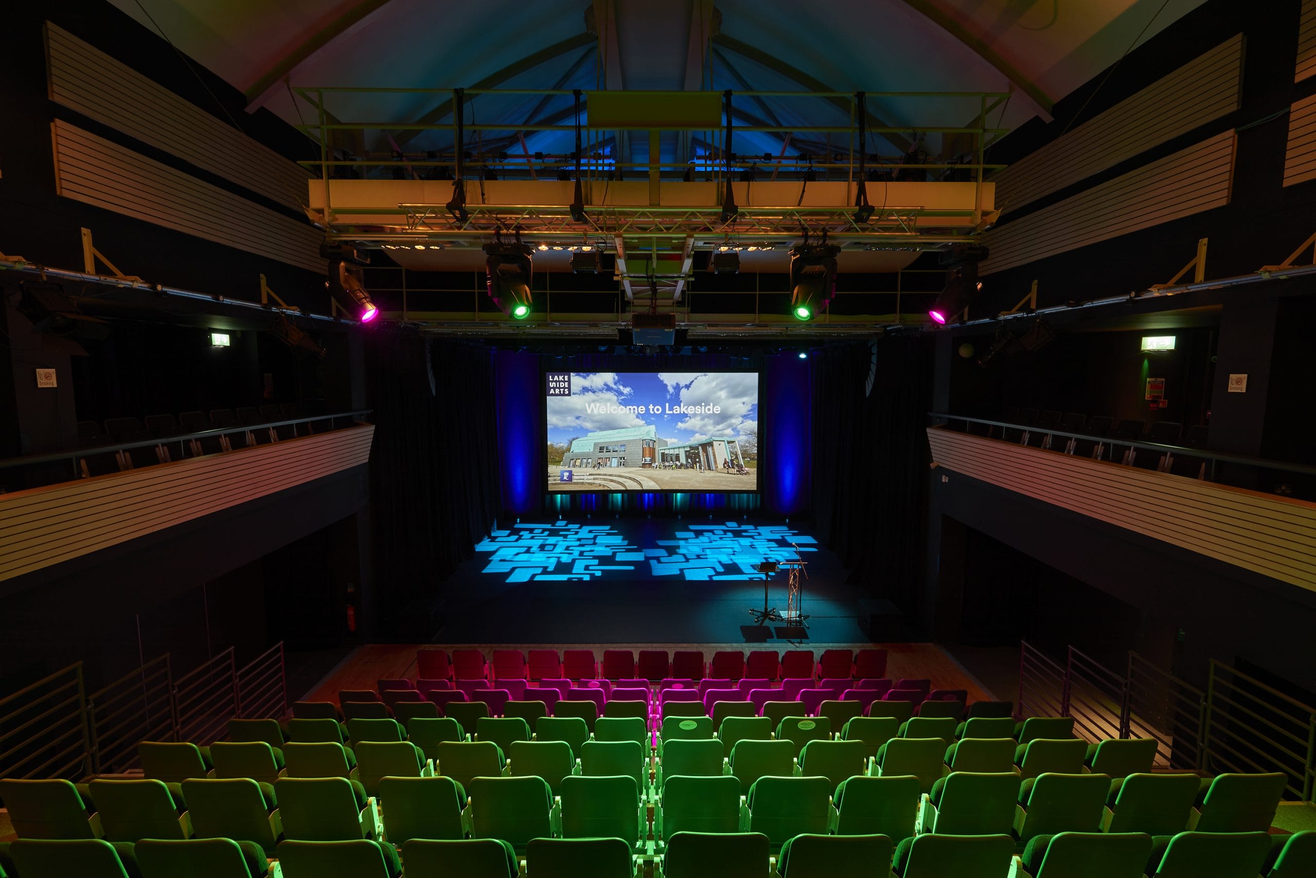 A theatre with 200 seats looking at a large screen