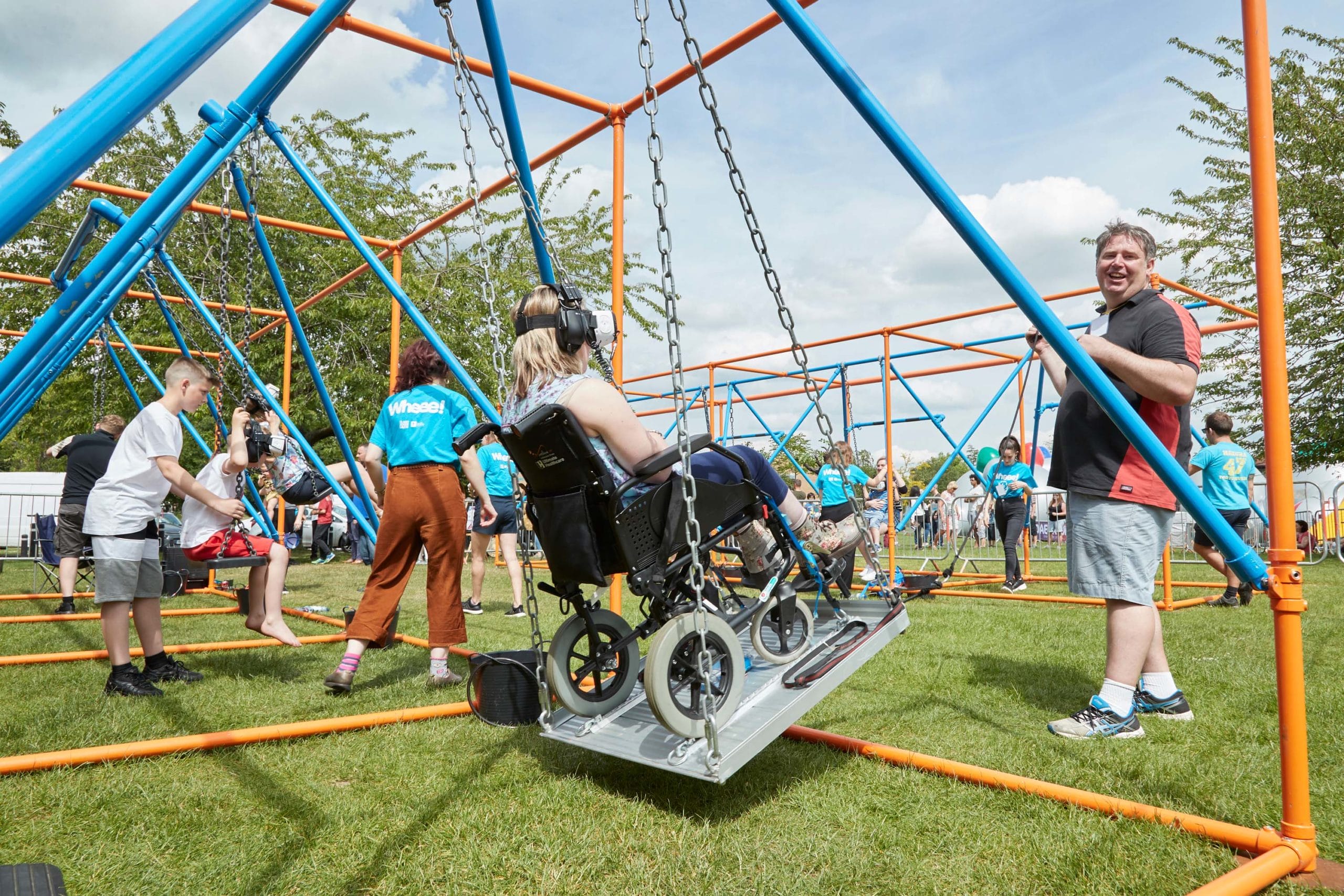A person in a wheelchair enjoys an accessible swing.