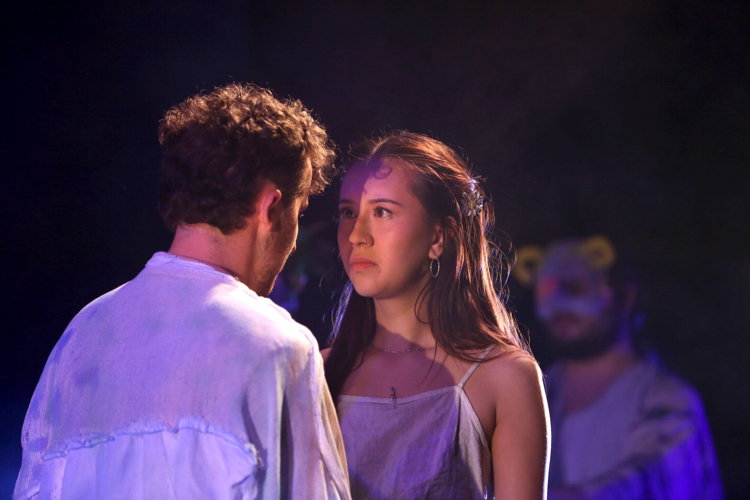 a girl looks into the eyes of a boy