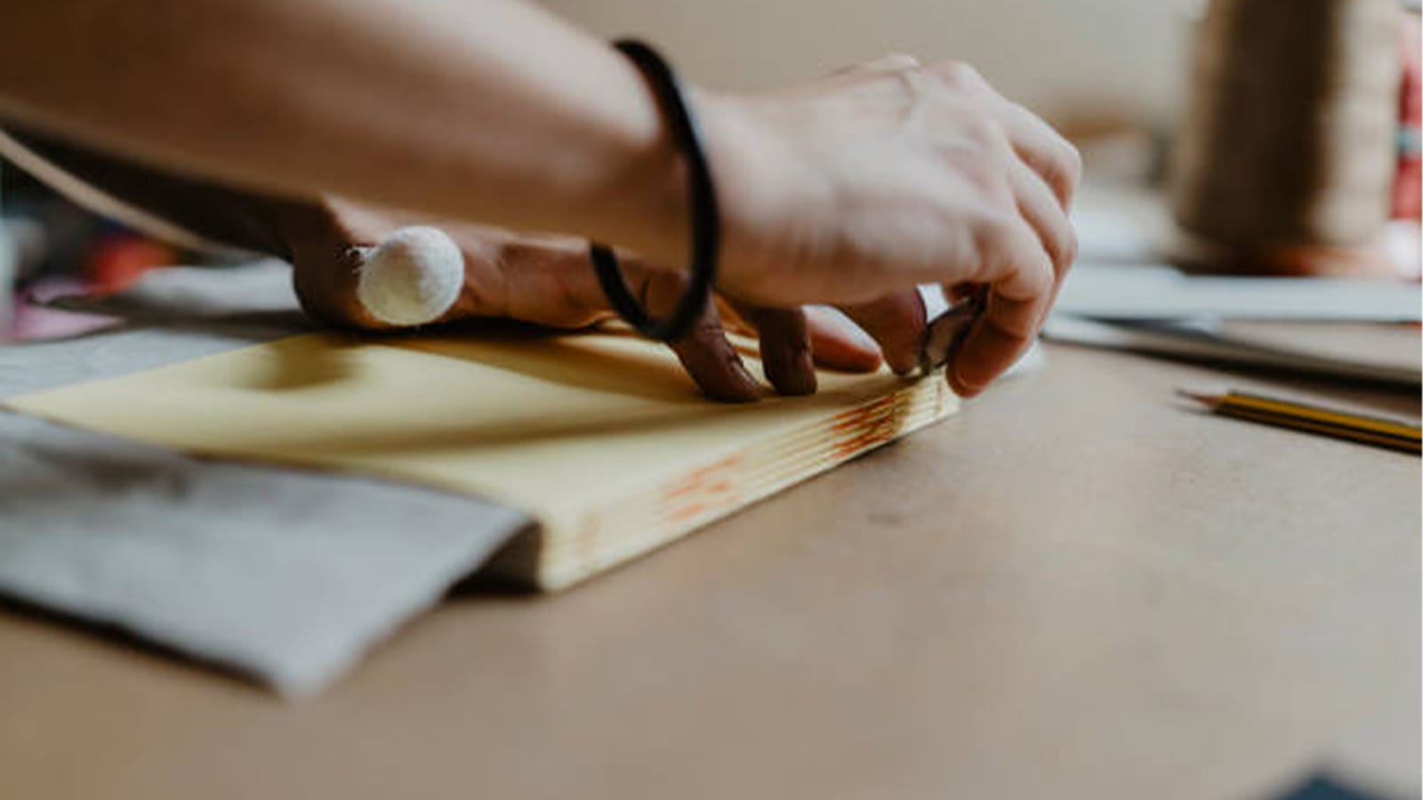 Hands crafting a book