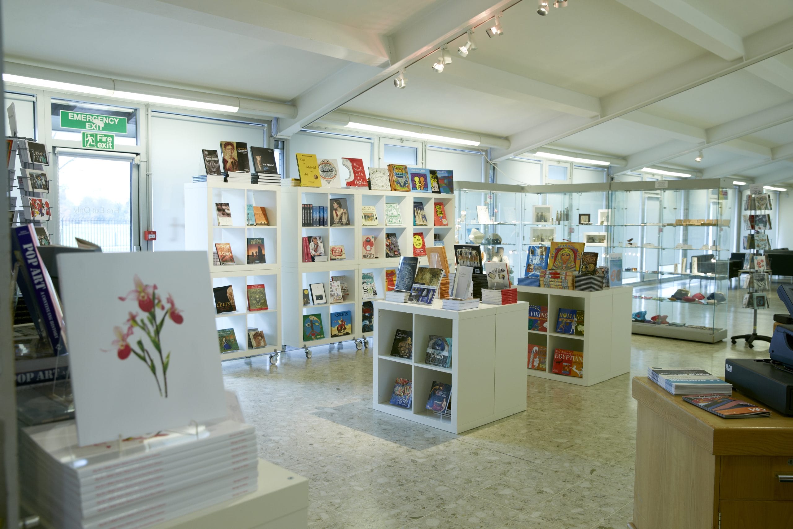 A light bright shop space with square shelves and colourful displays.