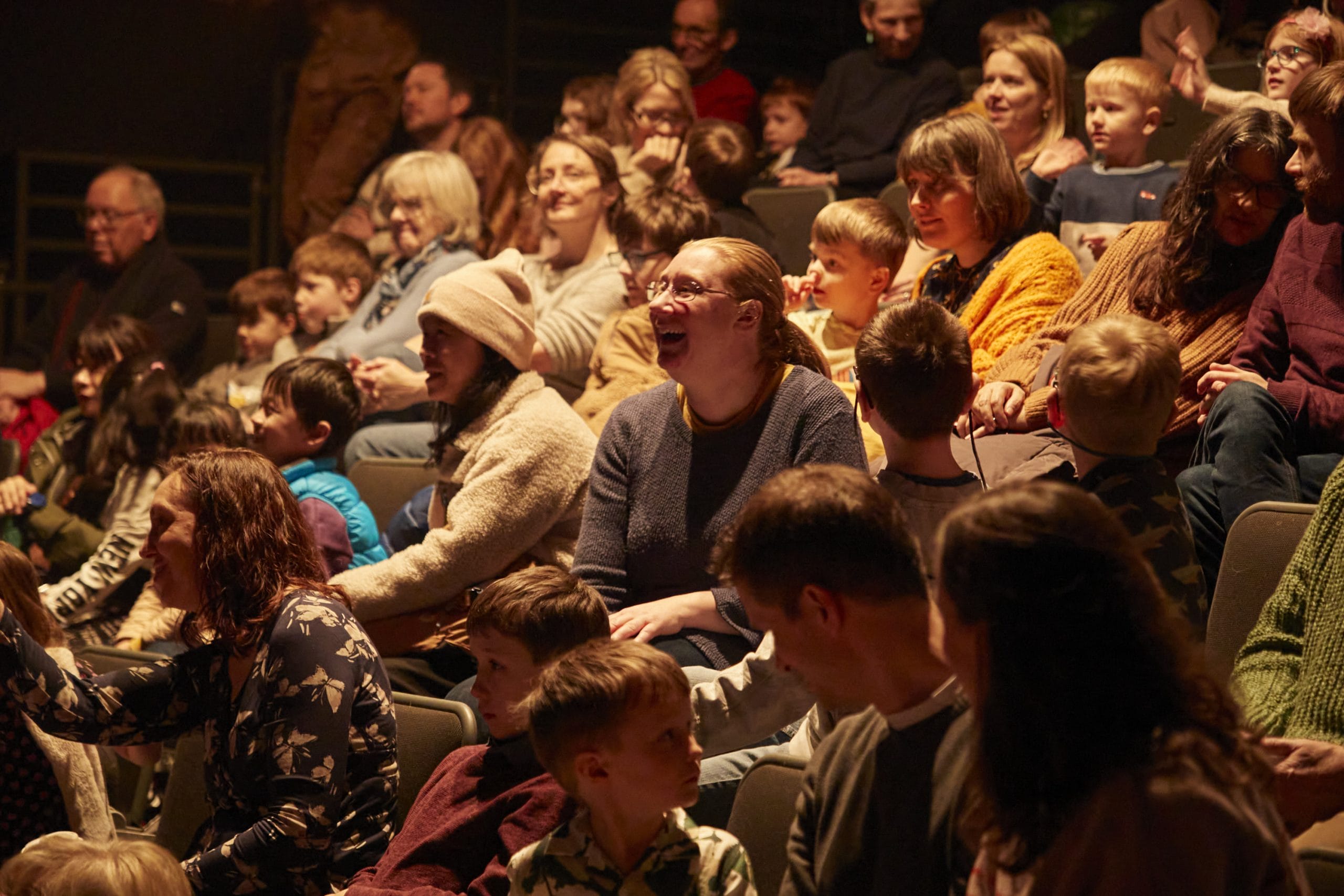 An audience smiling at a play at Lakeside Arts