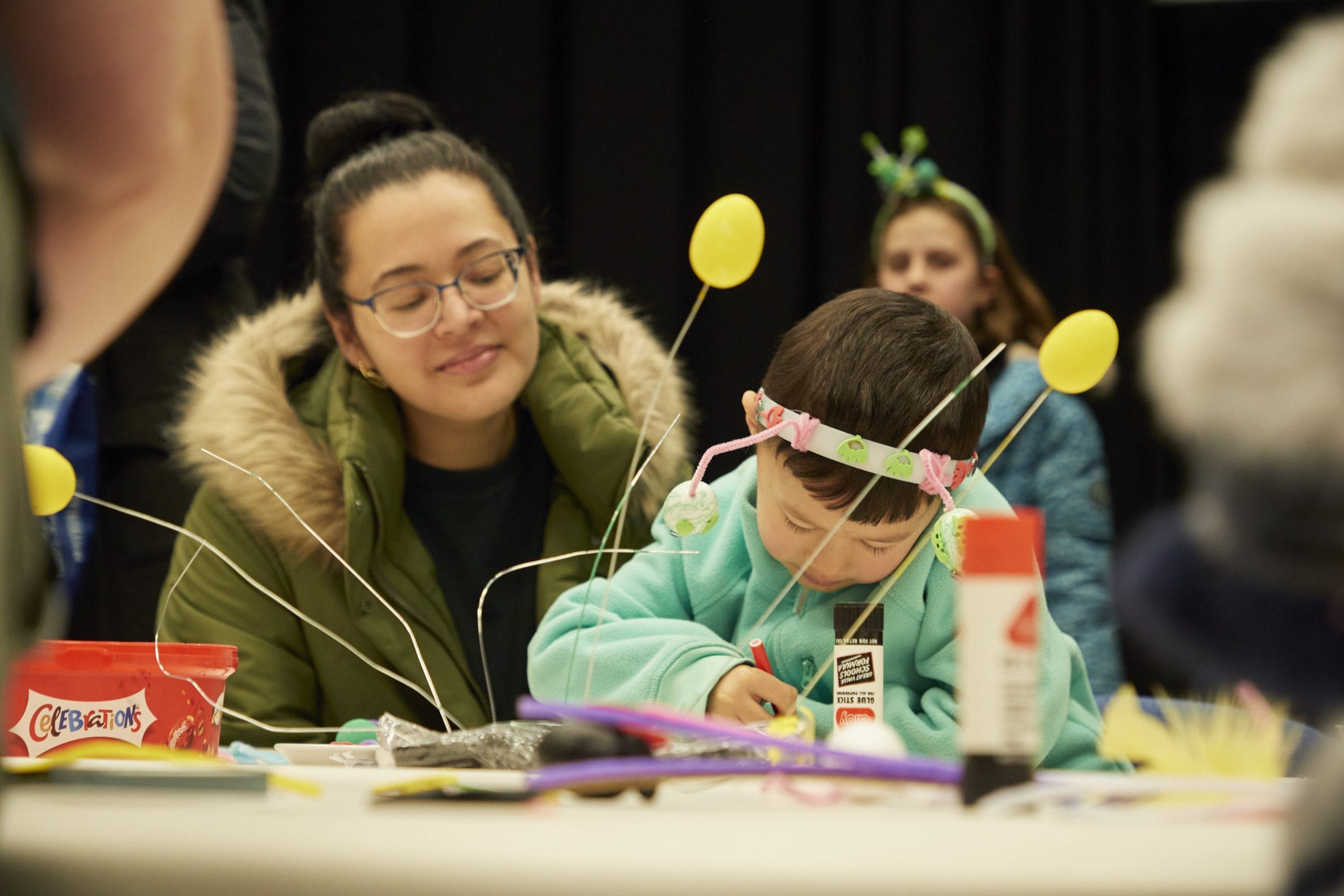 Child and parent working on a craft project