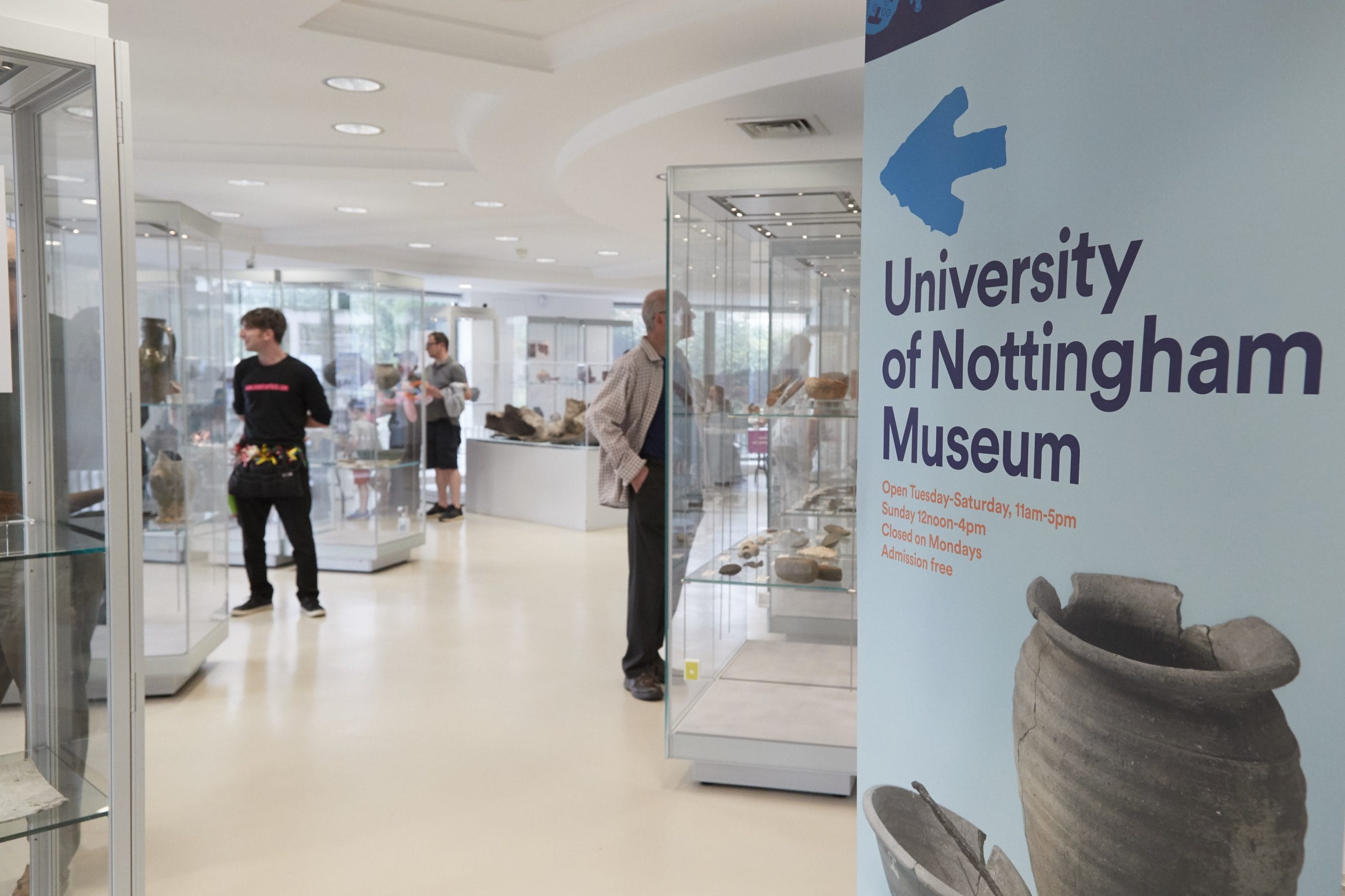 People are admiring artefacts in University of Nottingham Museum