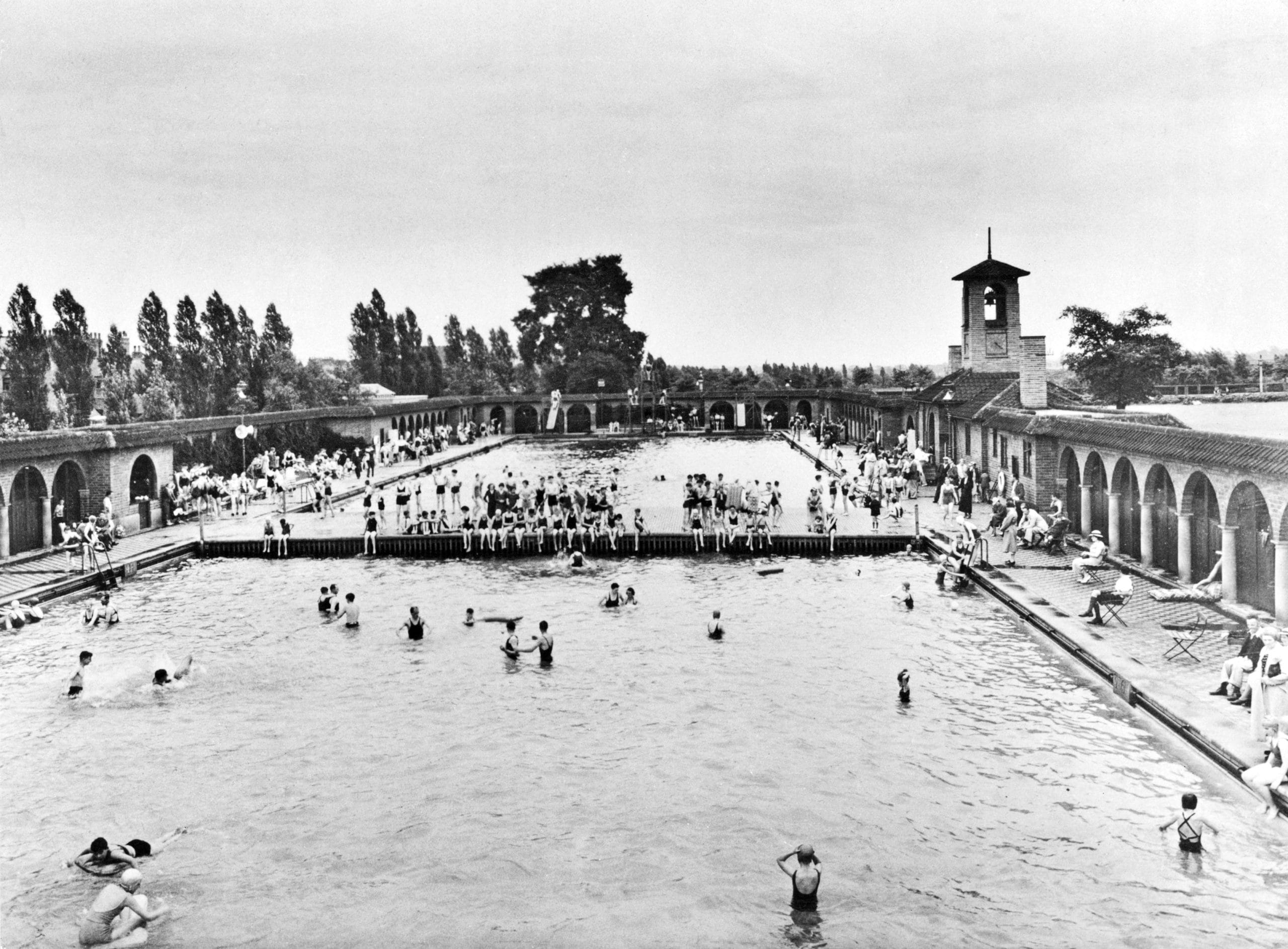 A black and white photograph of an outdoor swimming pool on the site where Lakeside Arts now sits