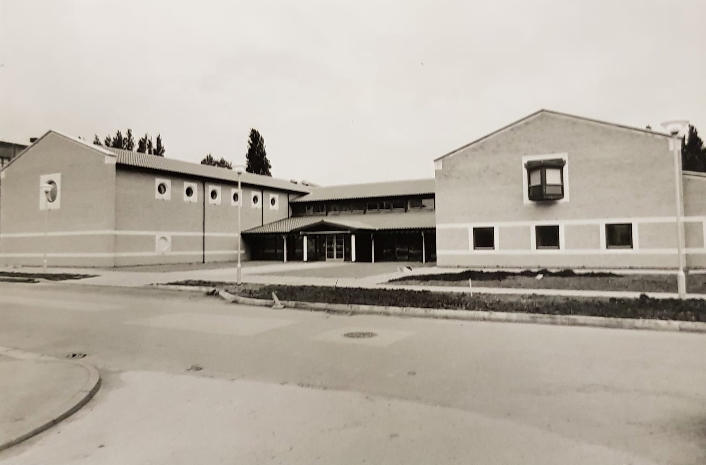 A black and white photo of the exterior of the recital hall