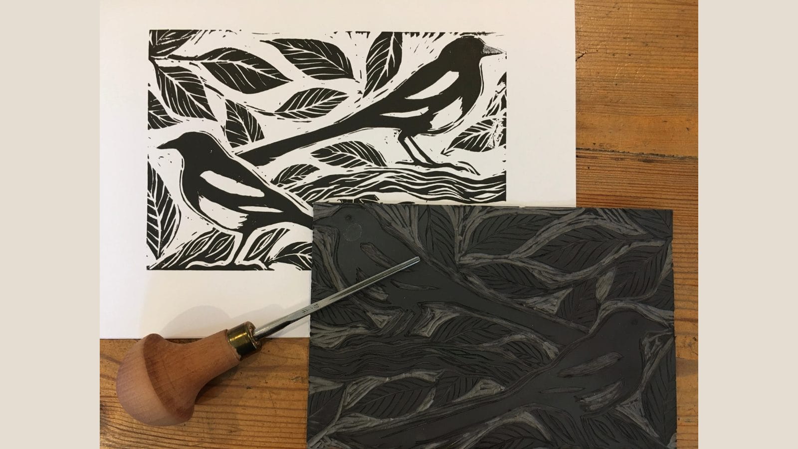 A black lino print of a bird