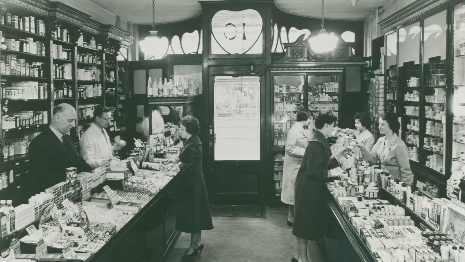 Black and white photo of the inside of a Boots Pharmacy