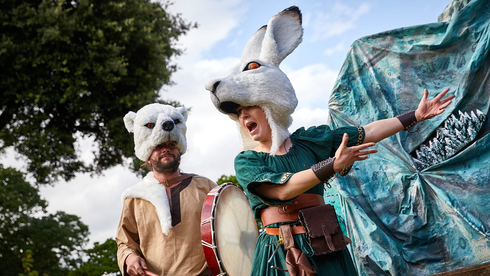 A woman dressed as a hare points to a man dressed as a polar bear
