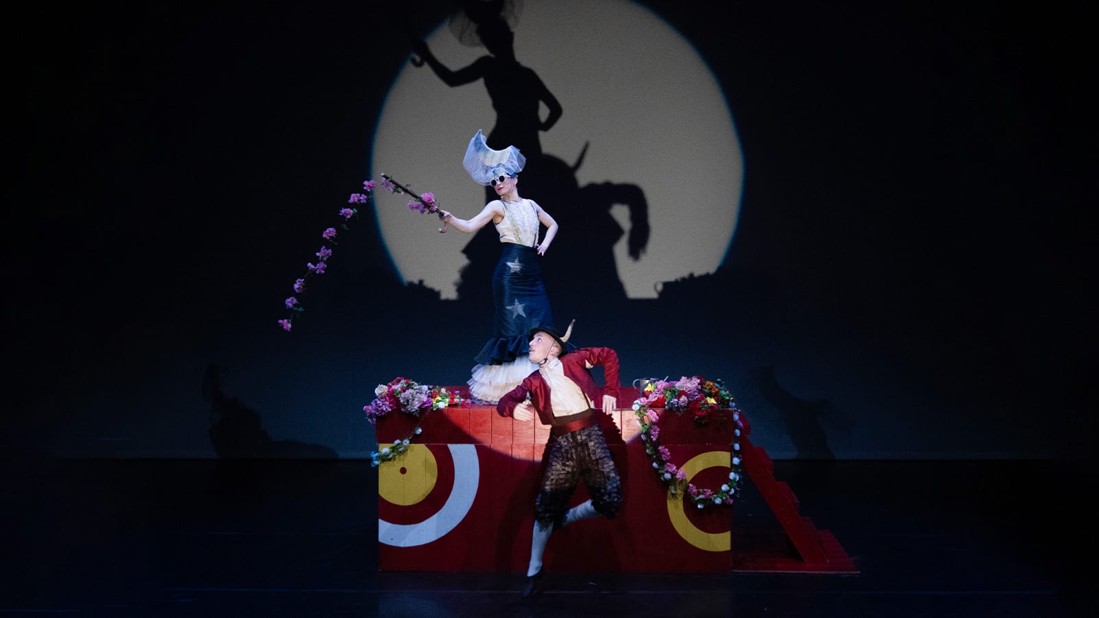 A man dressed as a bull tamer and a woman dressed as a bull flamenco dance