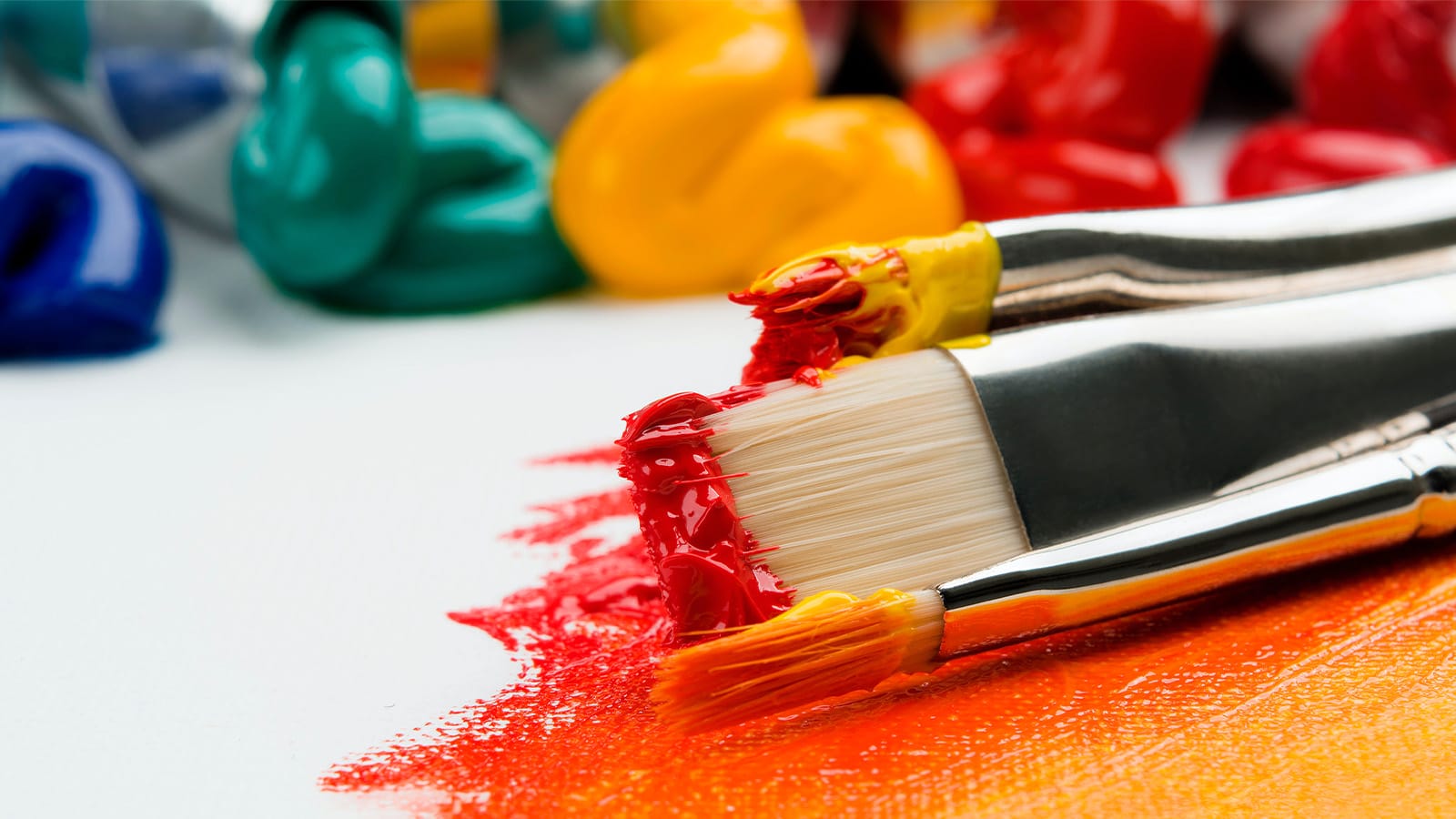 A paintbrush covered in orange paint