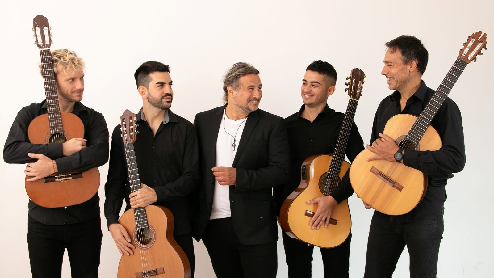 A group of men in suits hold spanish guitars
