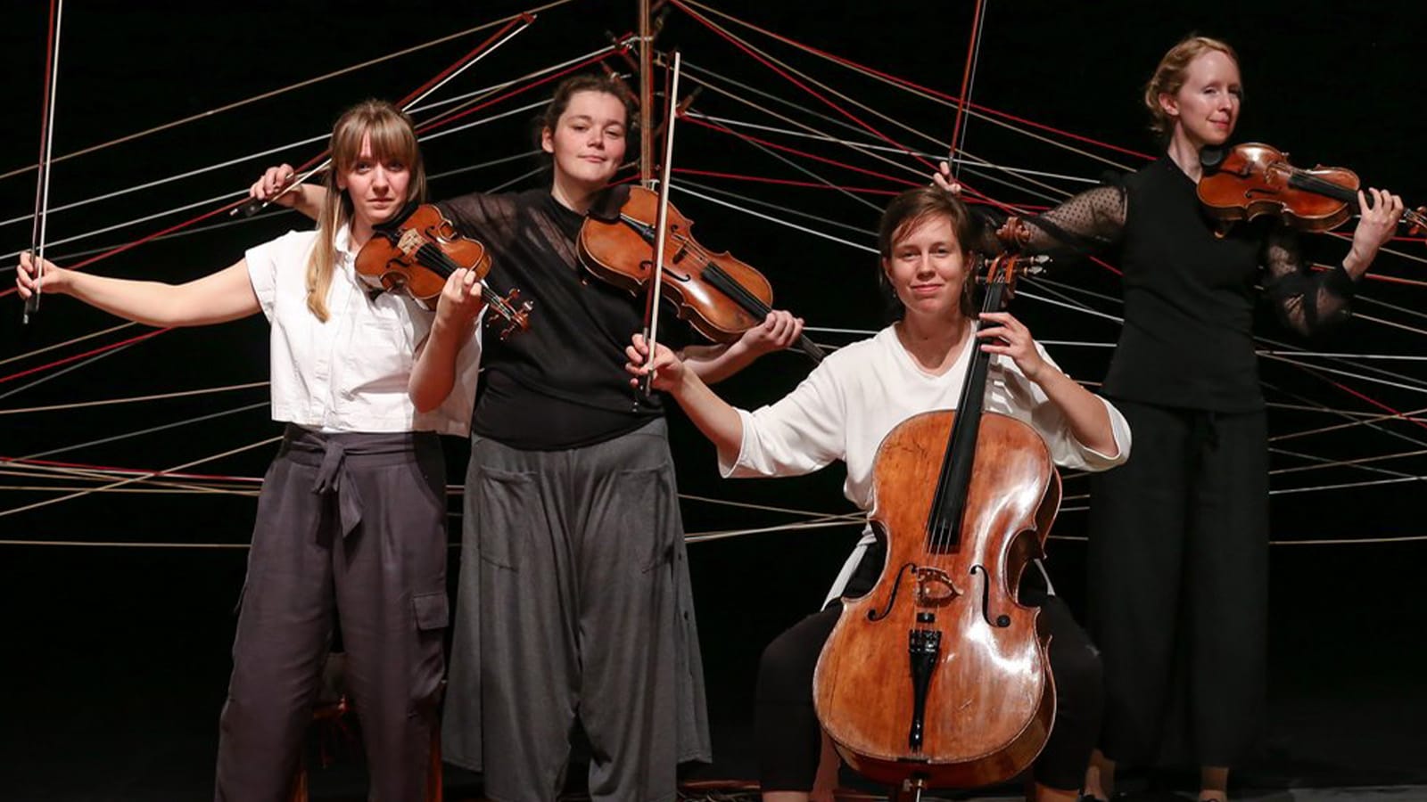 A group of performers playing string instruments