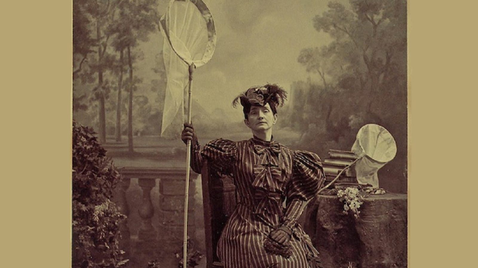 An old fashioned photo of a woman holding a butterfly net