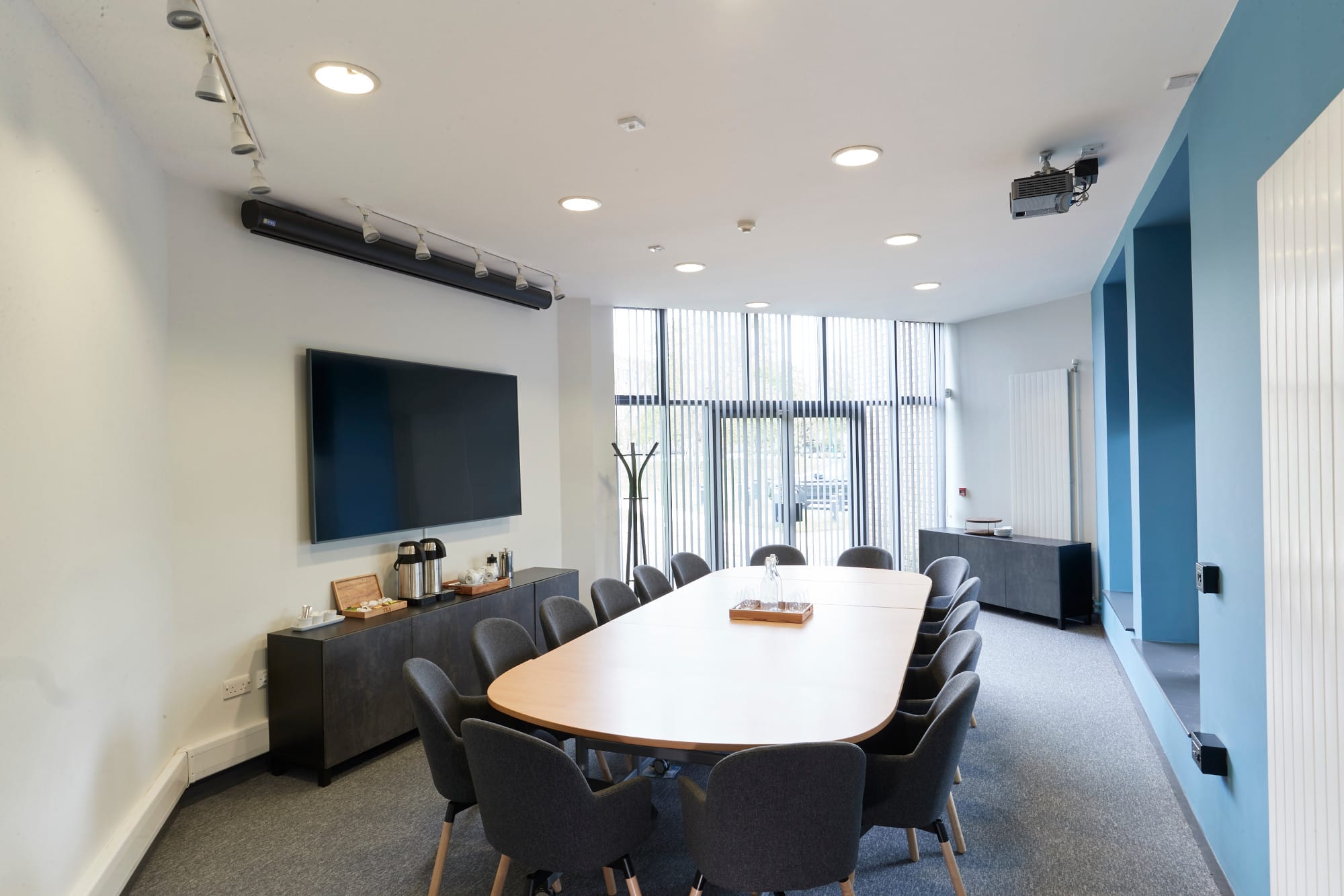Brightly lit meeting room with a board table and chairs.