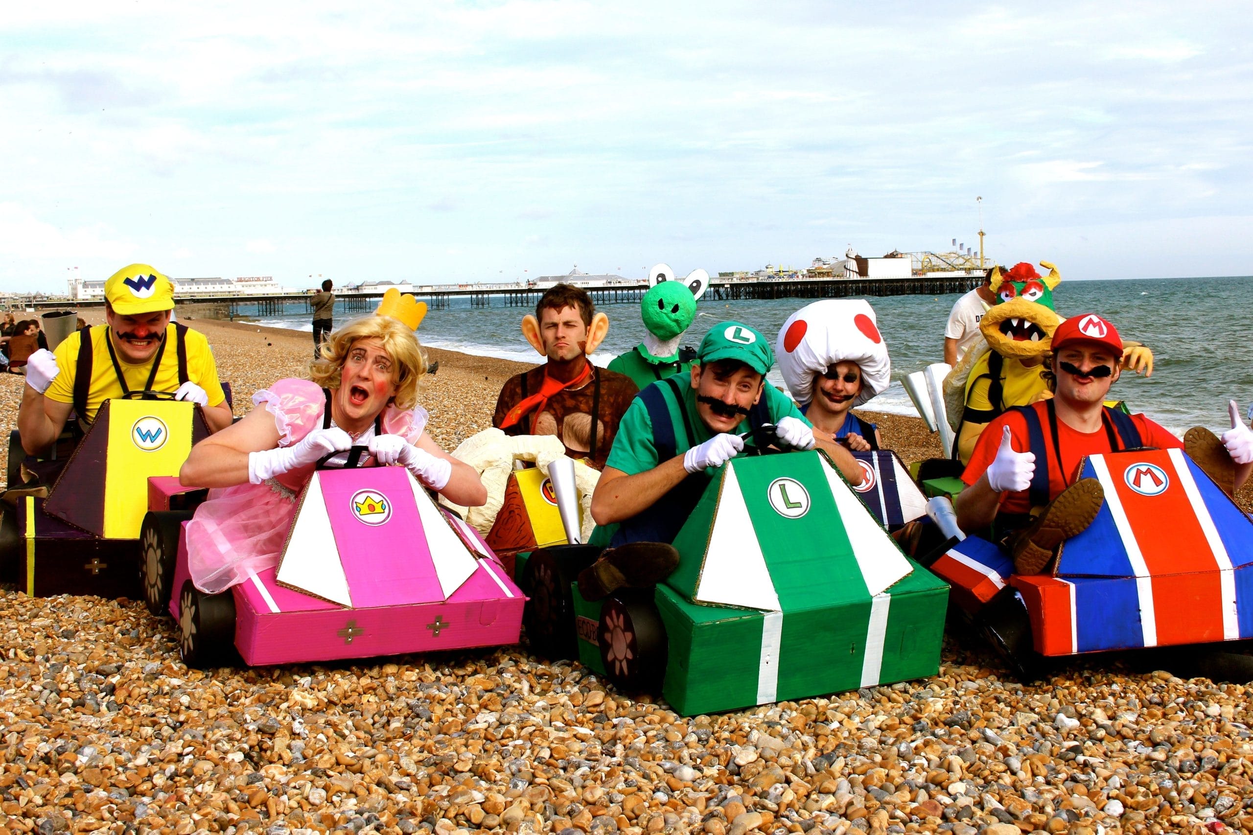 picture of 4 men in make shift Mario karts