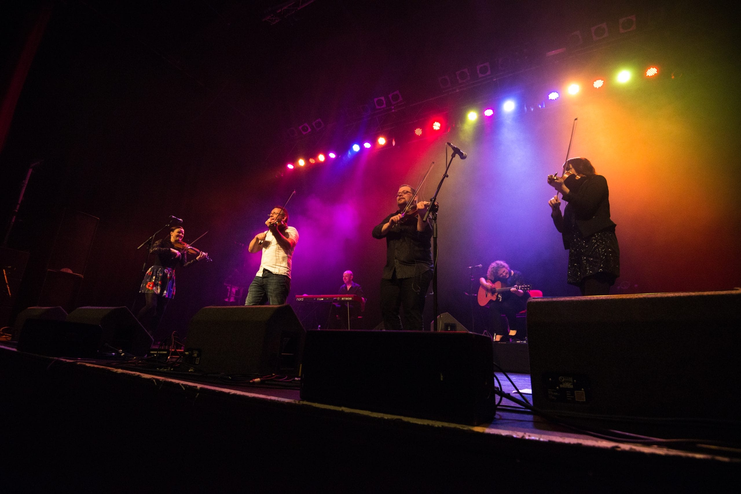 a photo of a Blazin FIddles' six musicians performing energetically