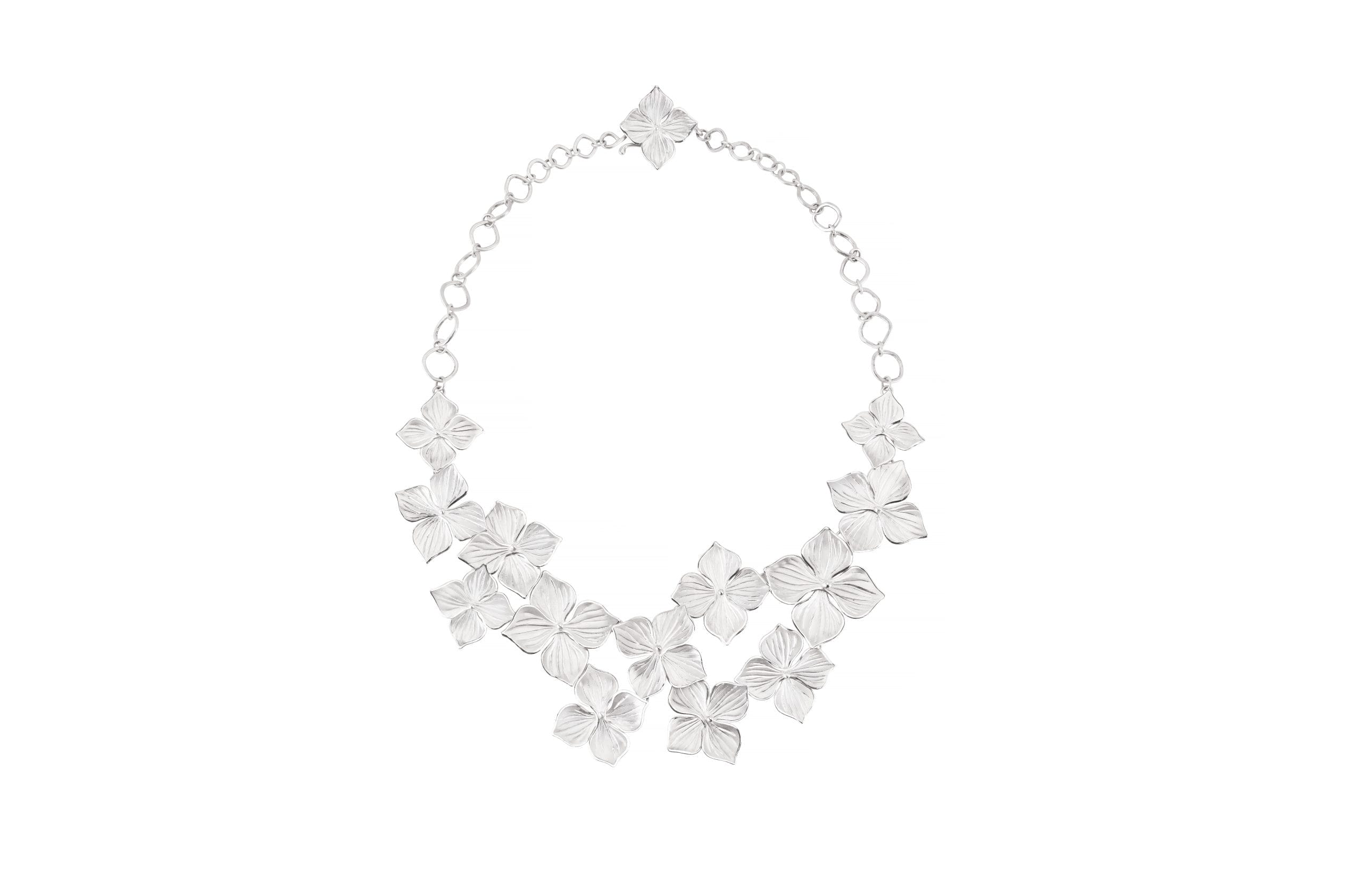 silver and diamond necklace on a white background