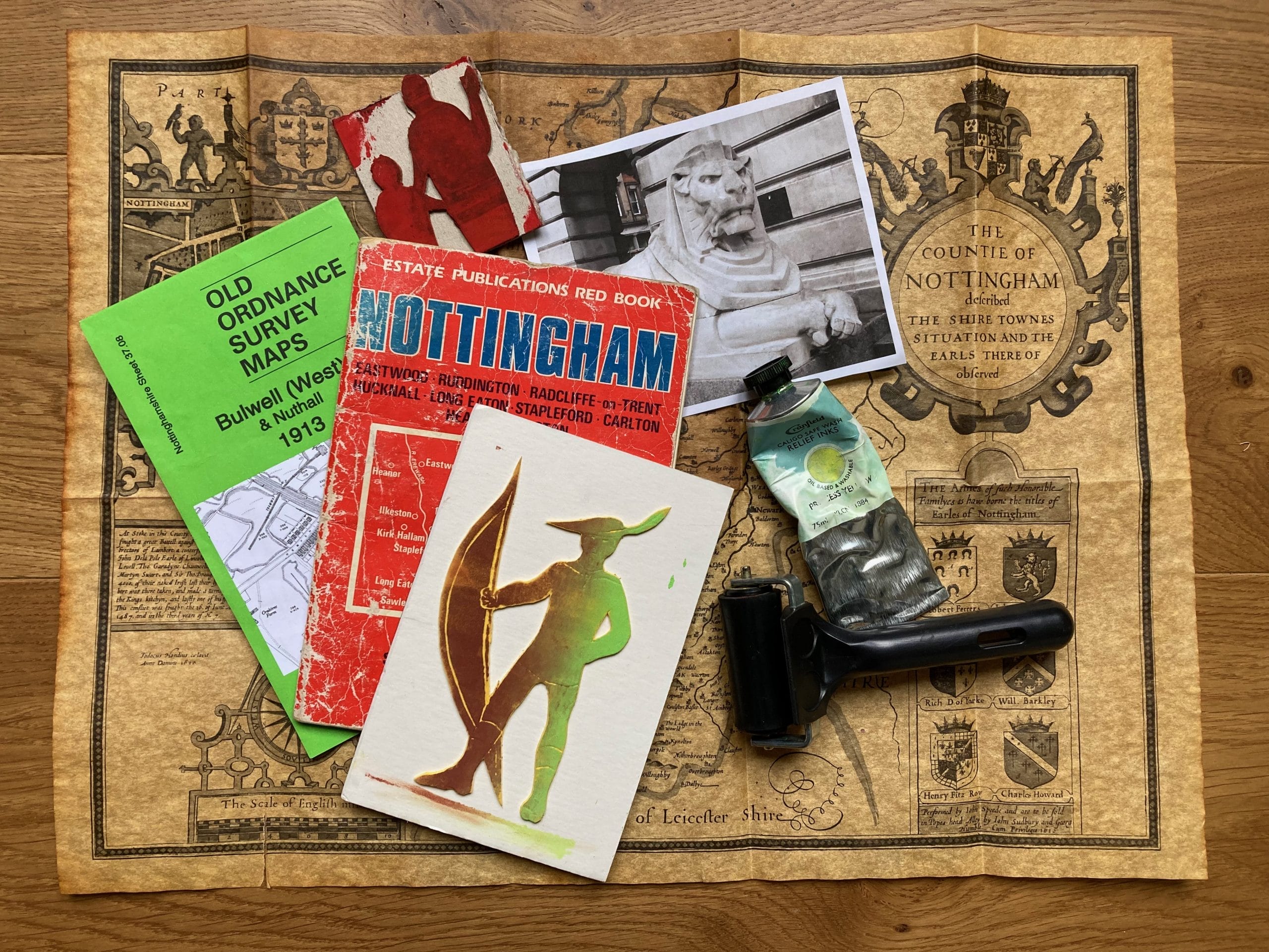 A selection of maps and Nottingham leaflets piled on top of each other.