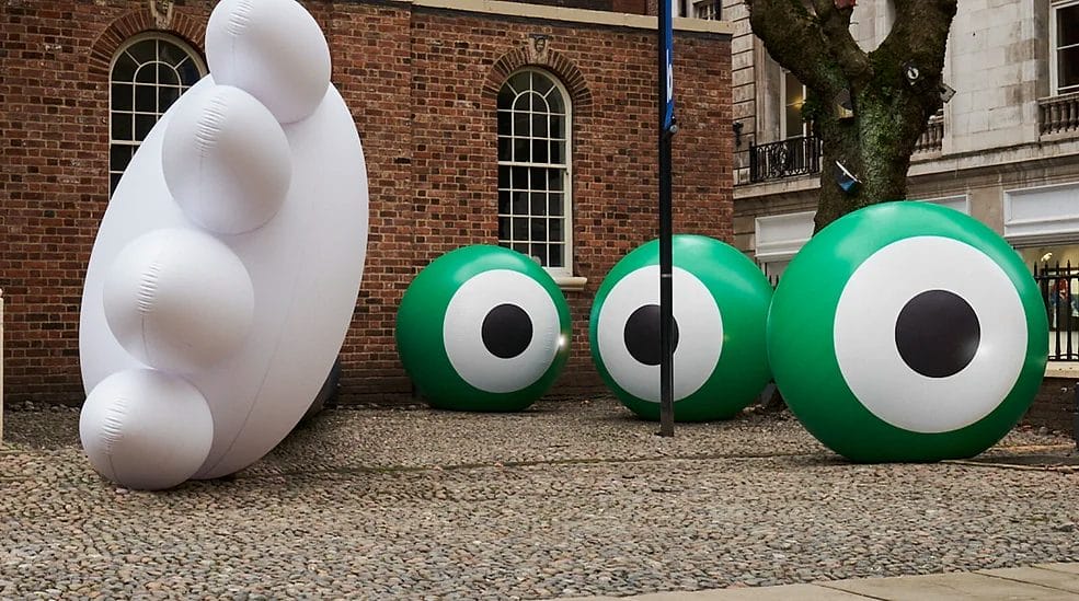 inflatables in front of red brick building