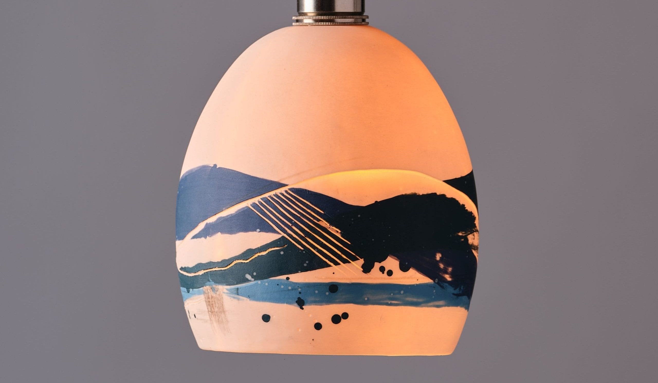 a lit glass sea lampshade hanging from the ceiling