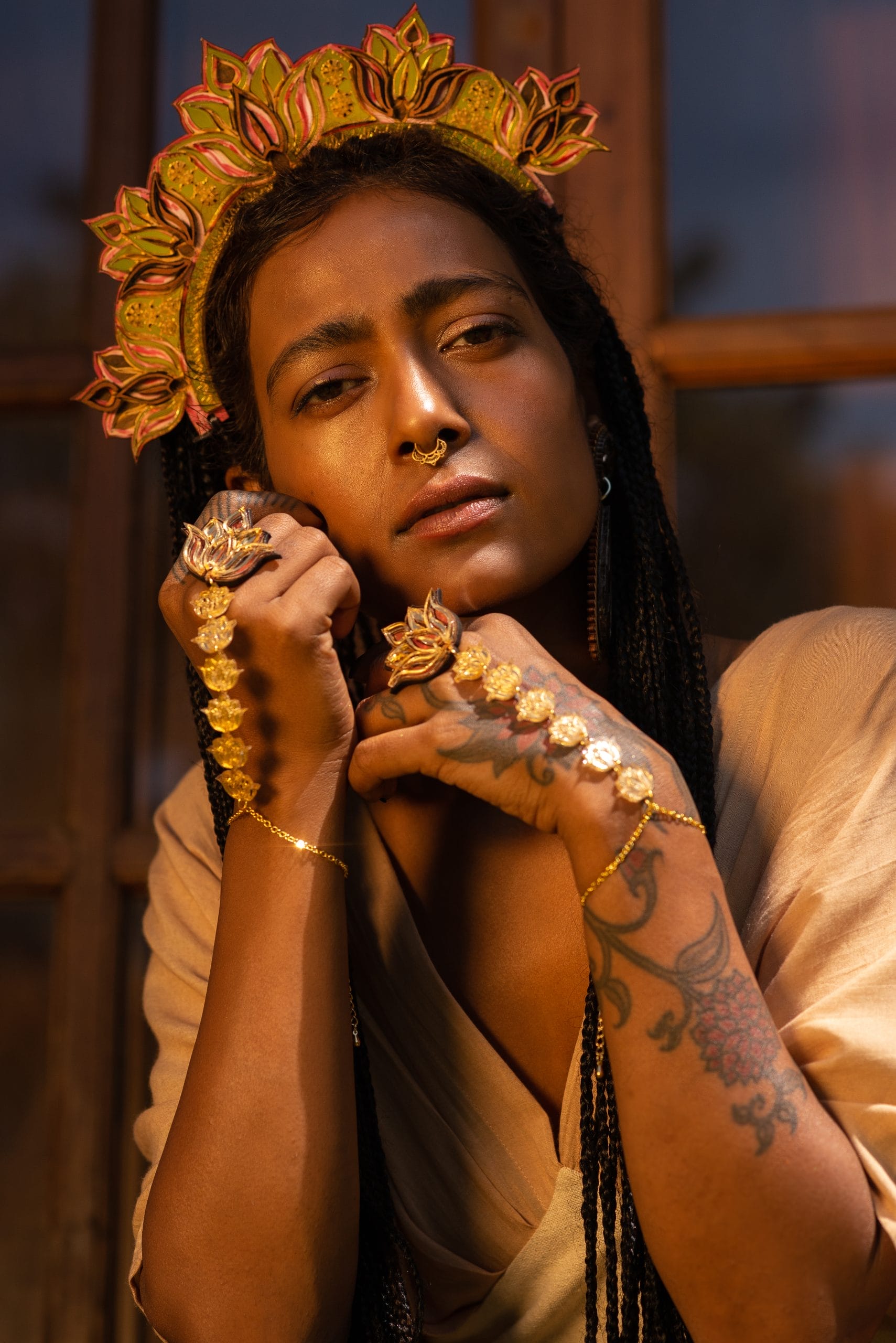 a lady with long dark hair wearing gold jewellery