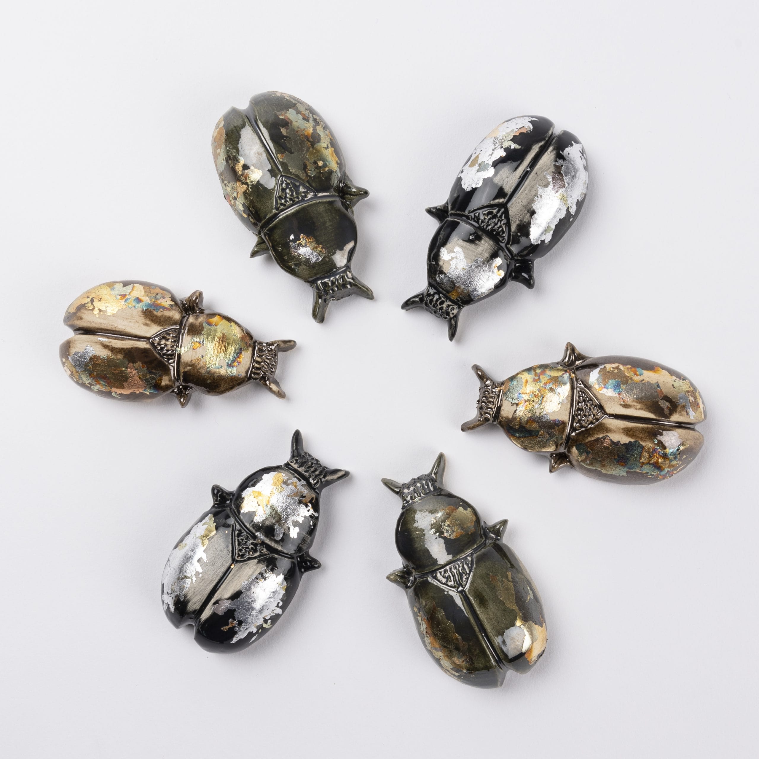 6 metal beetles in a circle