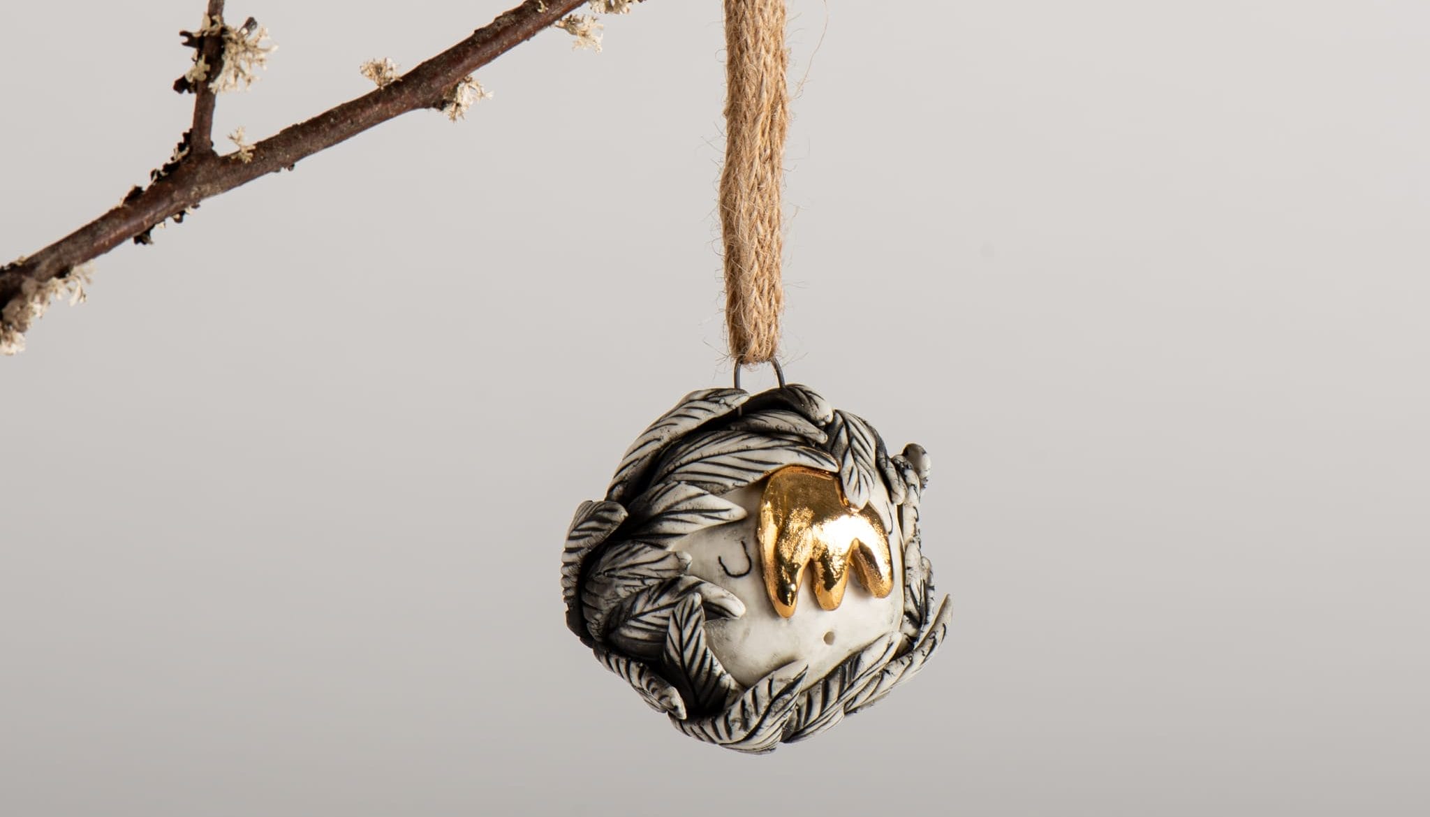 a decorative circular item hanging from a branch