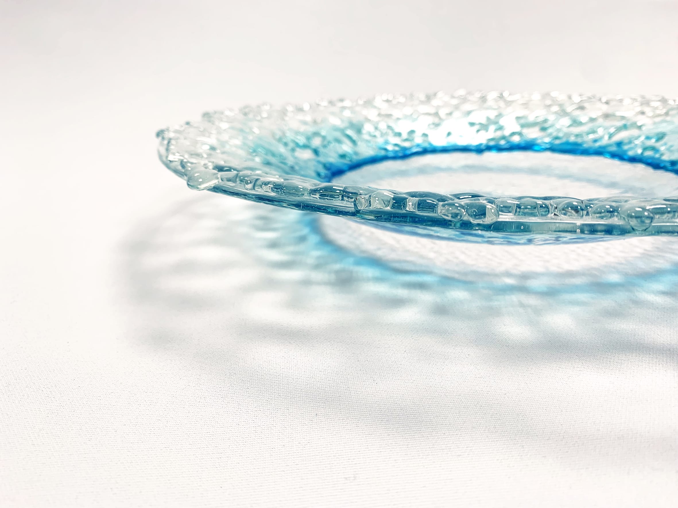 blue and clear decorative plate on a white background