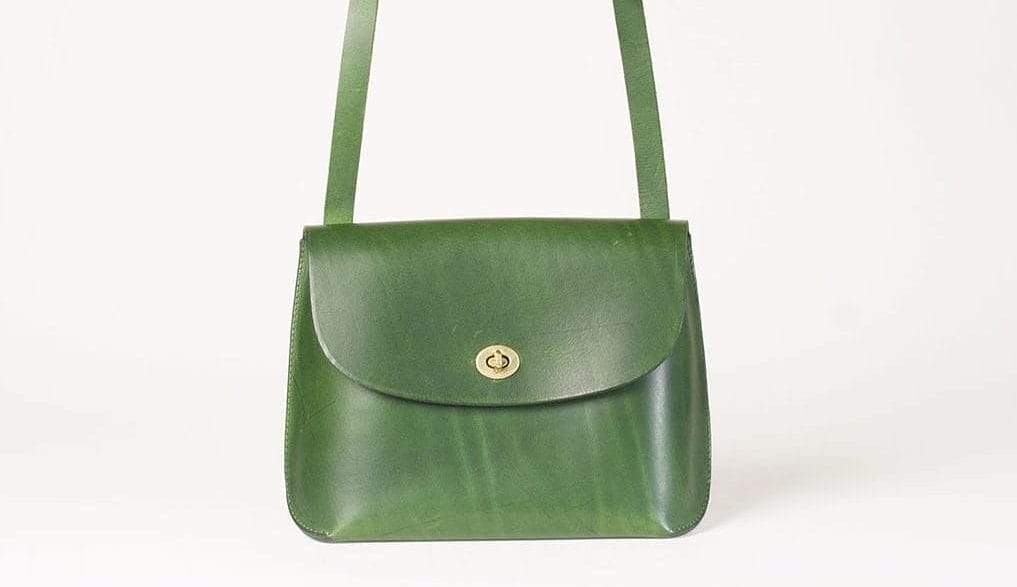 a green handbag on a white background