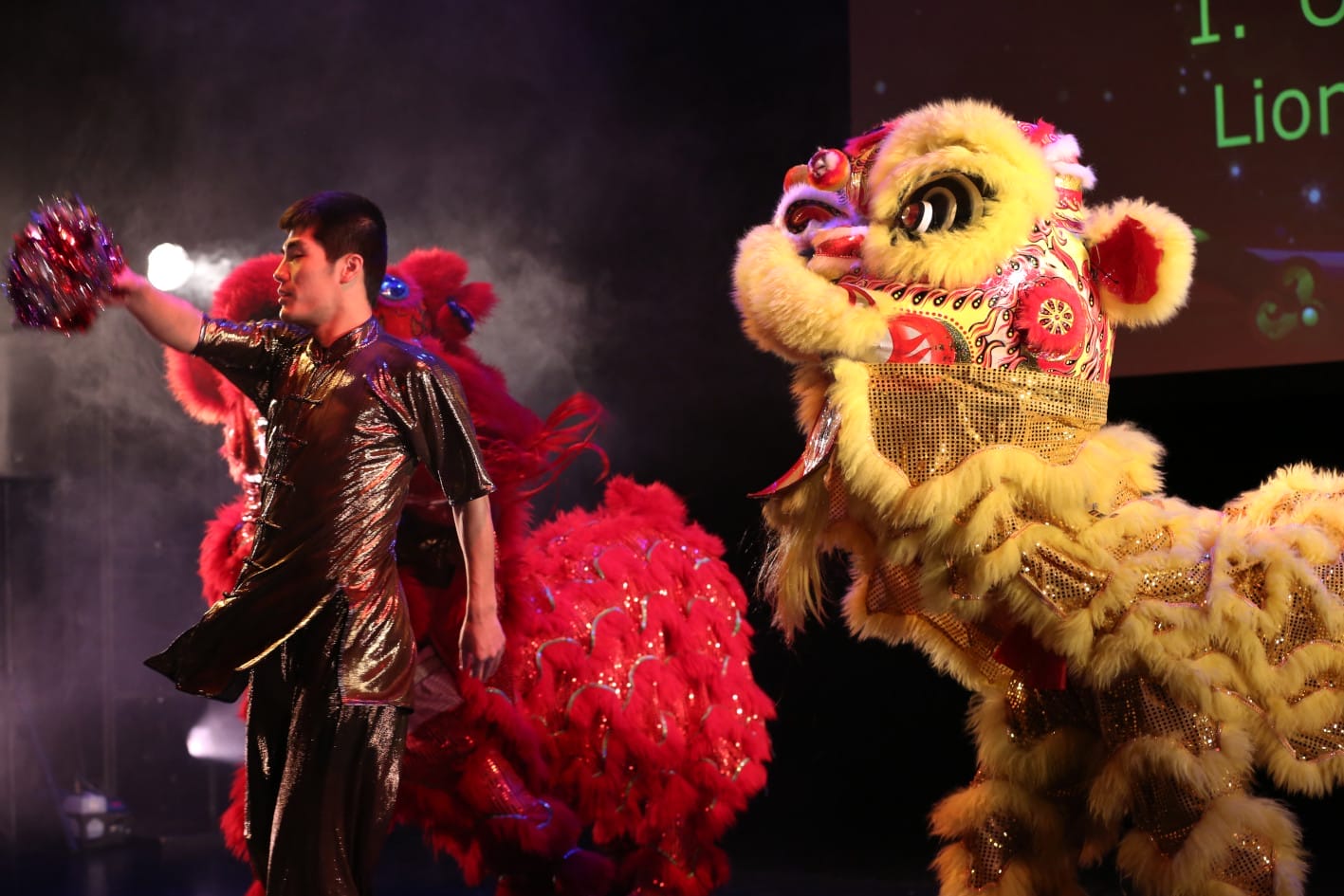 Performer on stage with Chinese dragons