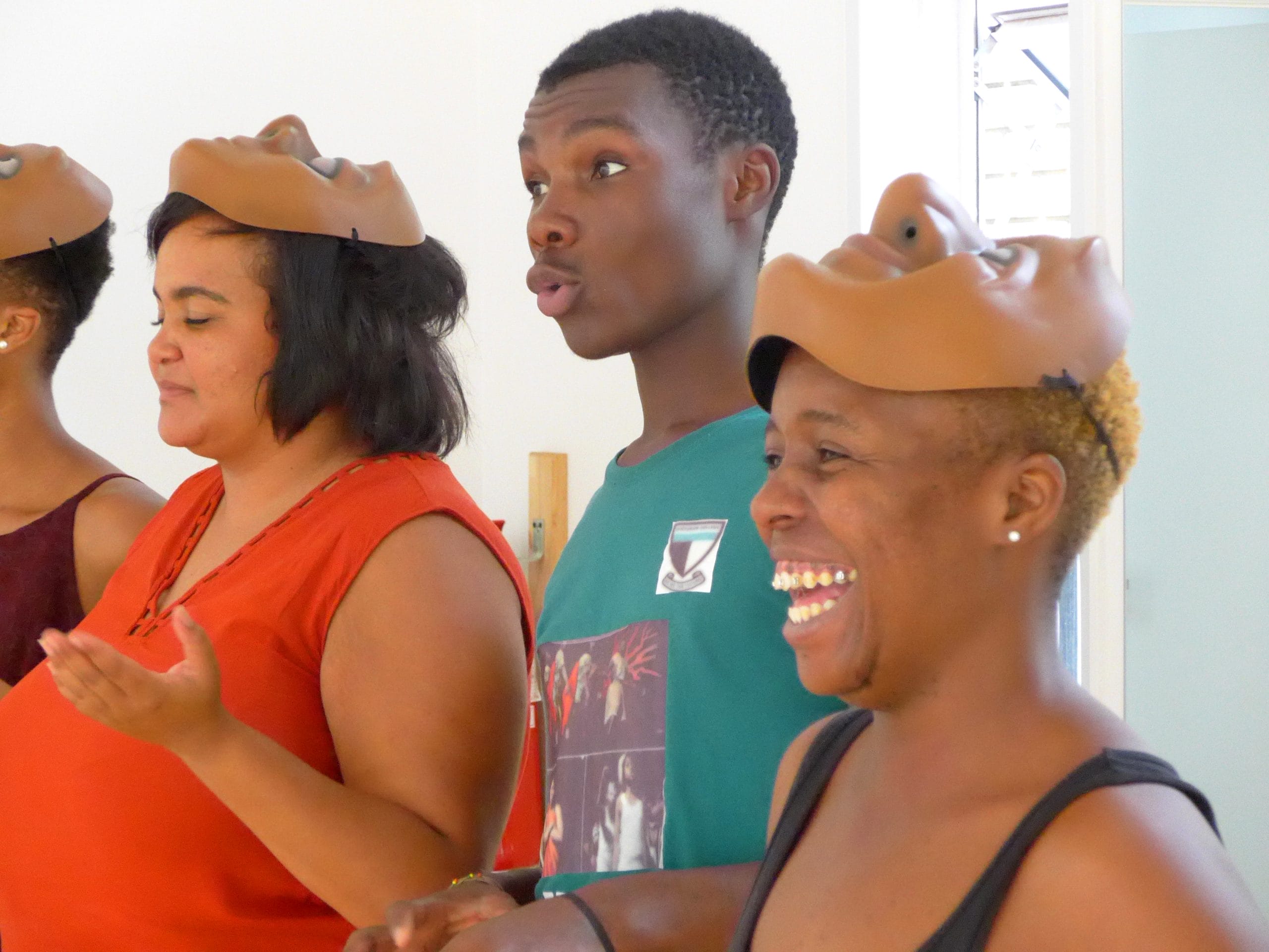 A group of people enjoying a mask workshop