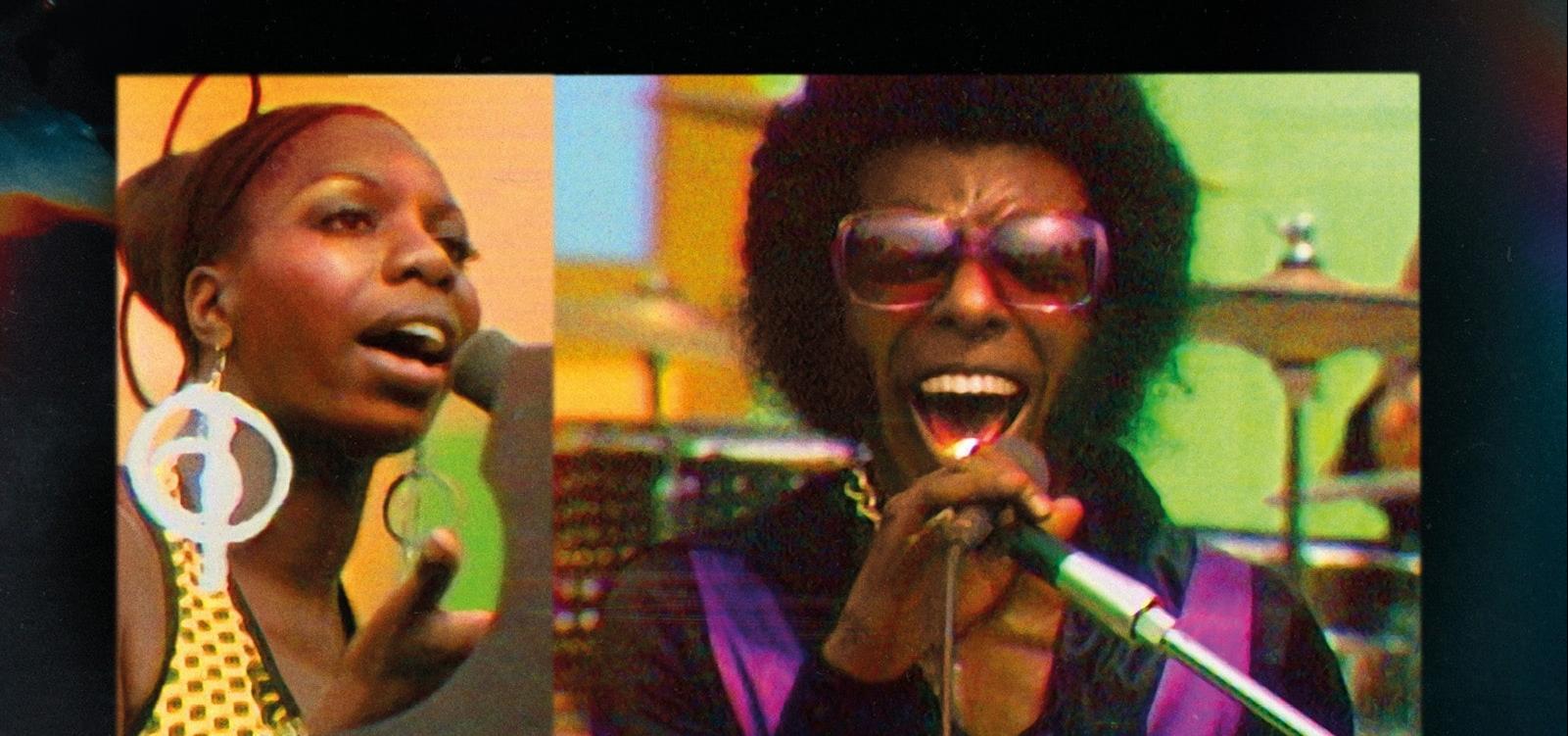 Two singers sing into microphones in a scene set in 1970s.