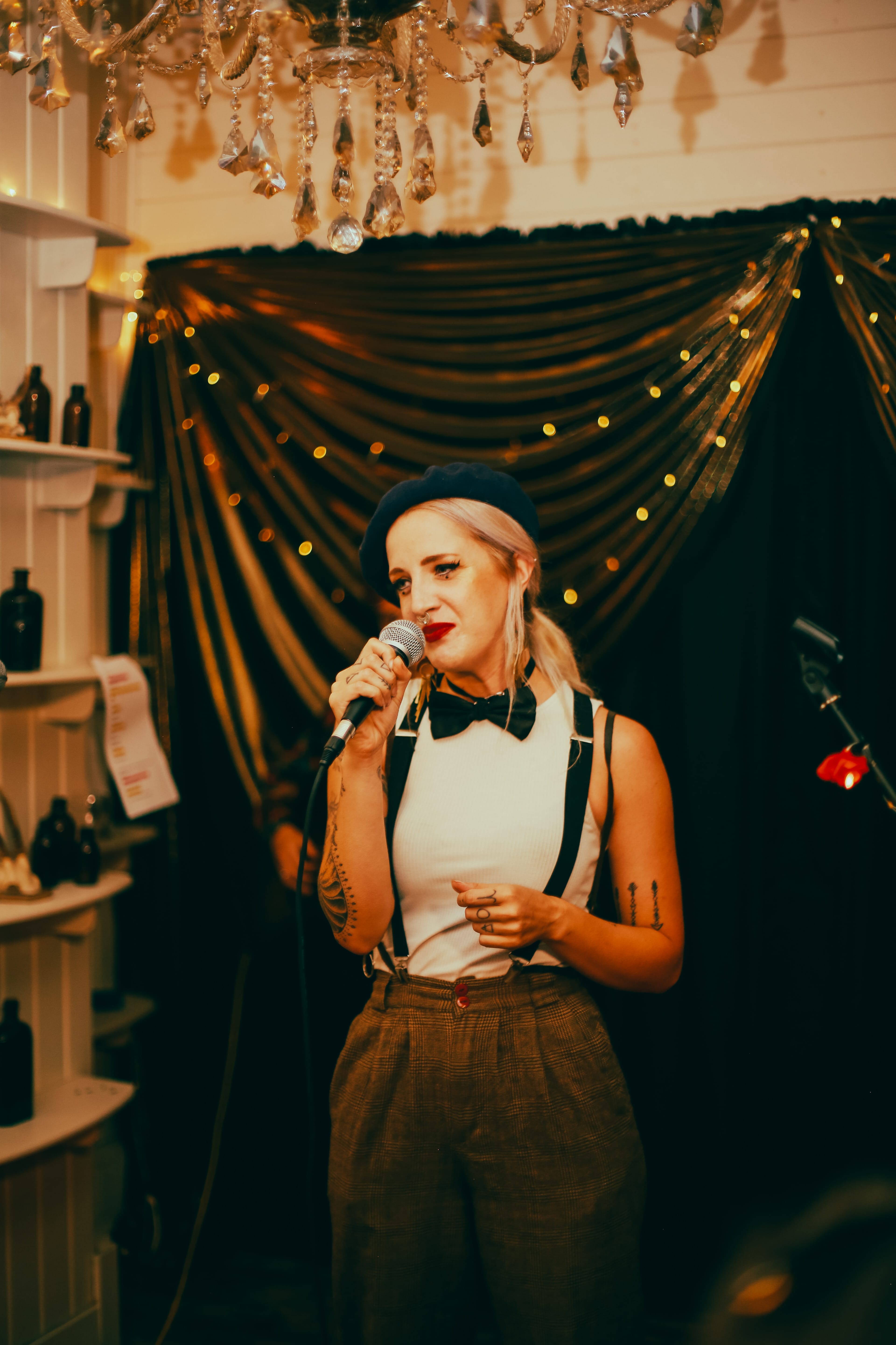 Naomi Woods, a female performer speaks into a microphone
