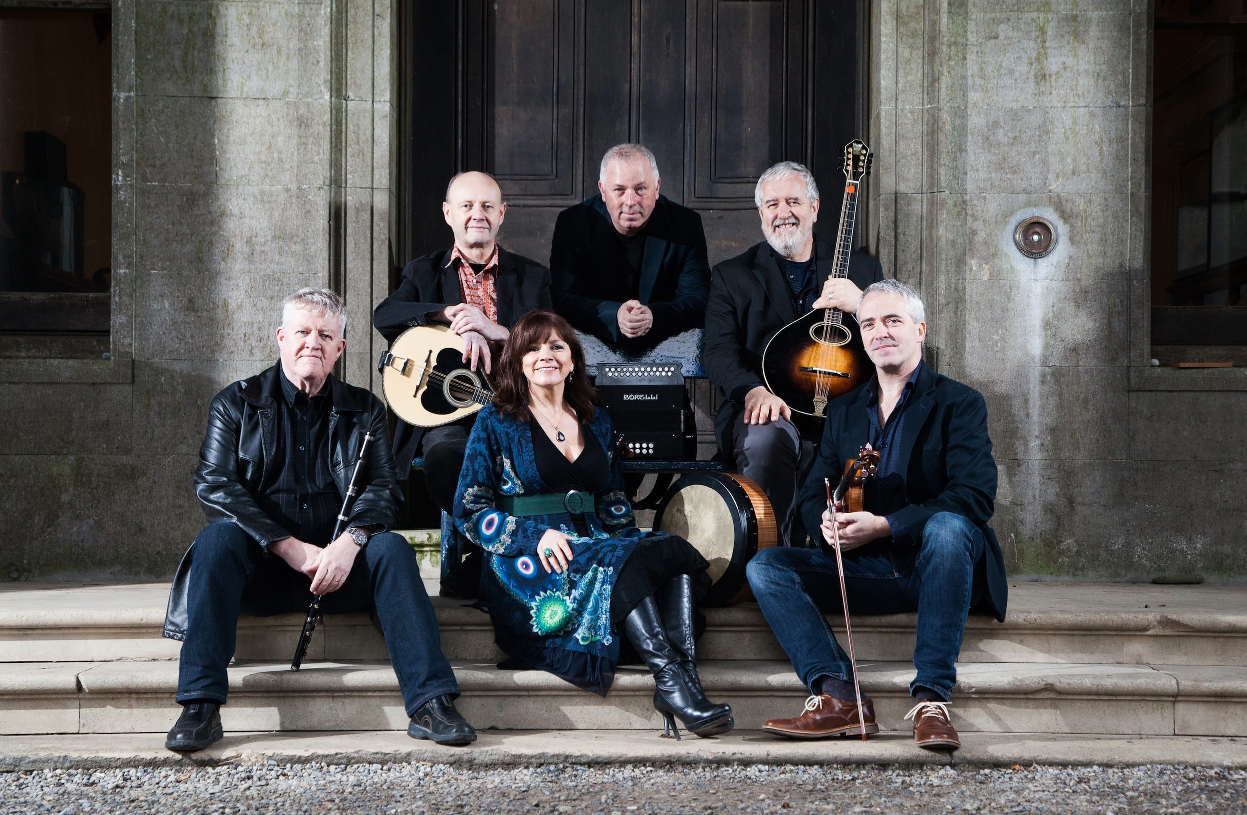 The band is assembled with their instruments