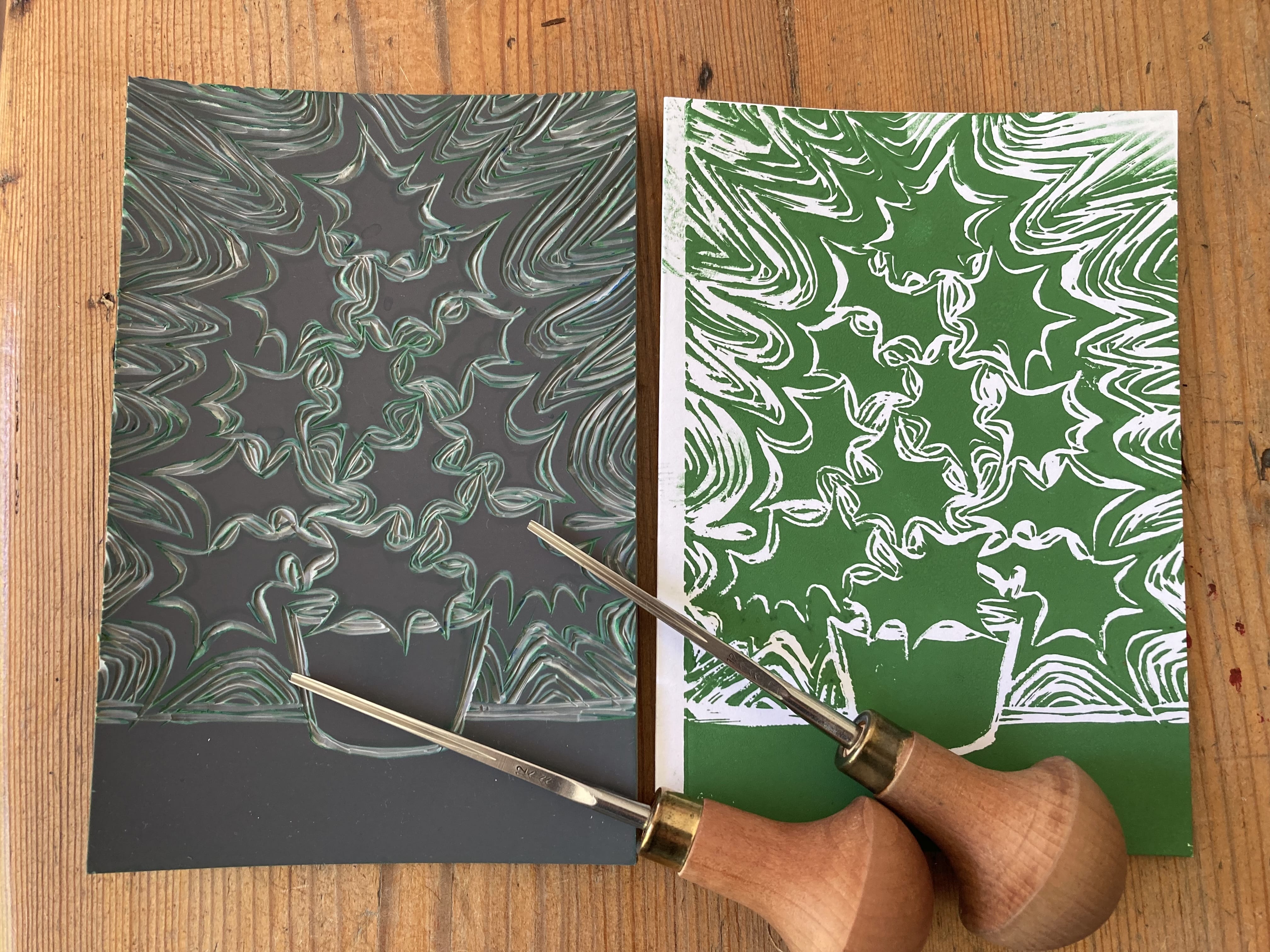 Two prints created by linocut printing, a holly bush sitting in a plant pot.