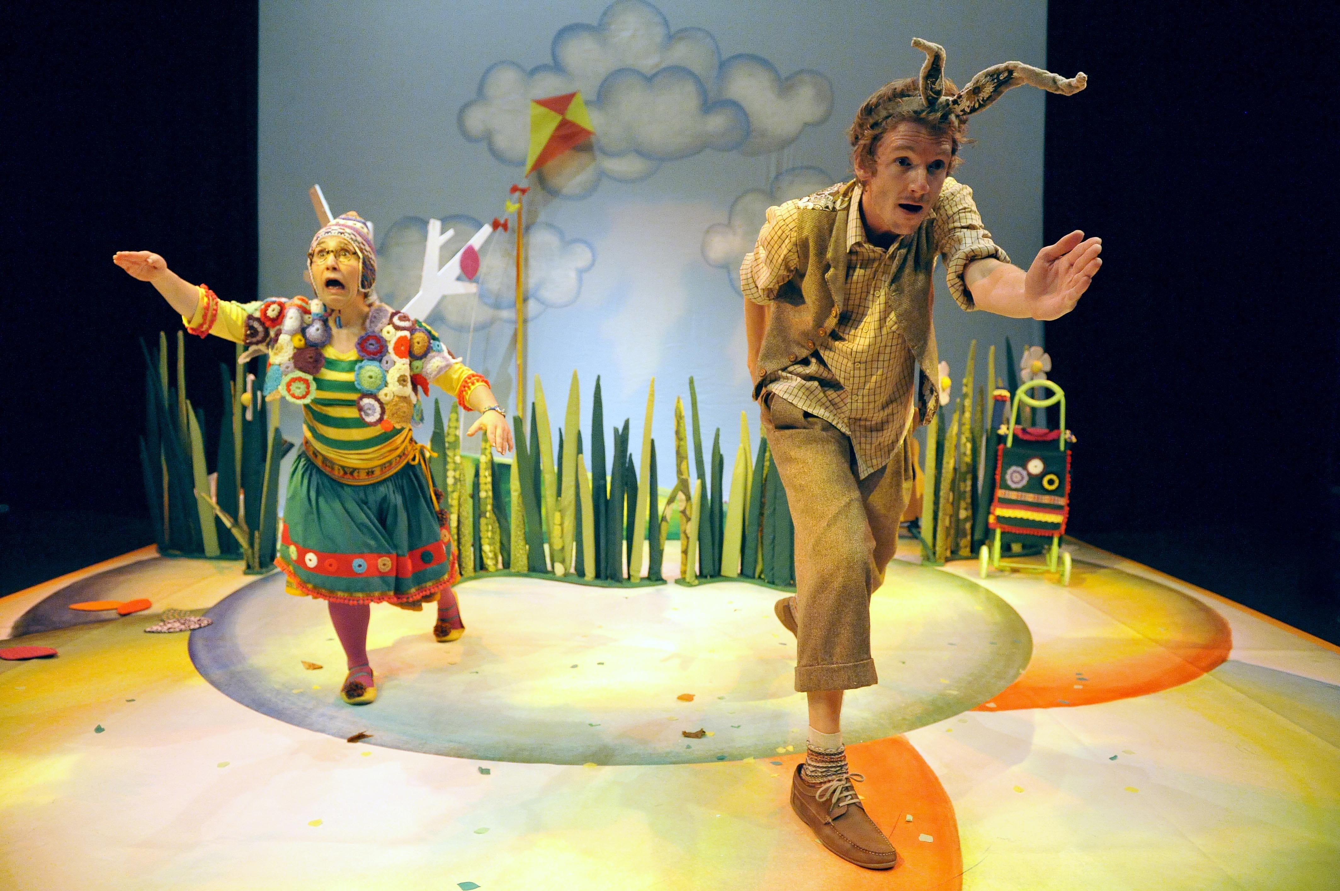 two actors dressed as a hare and tortoise are running next to each other
