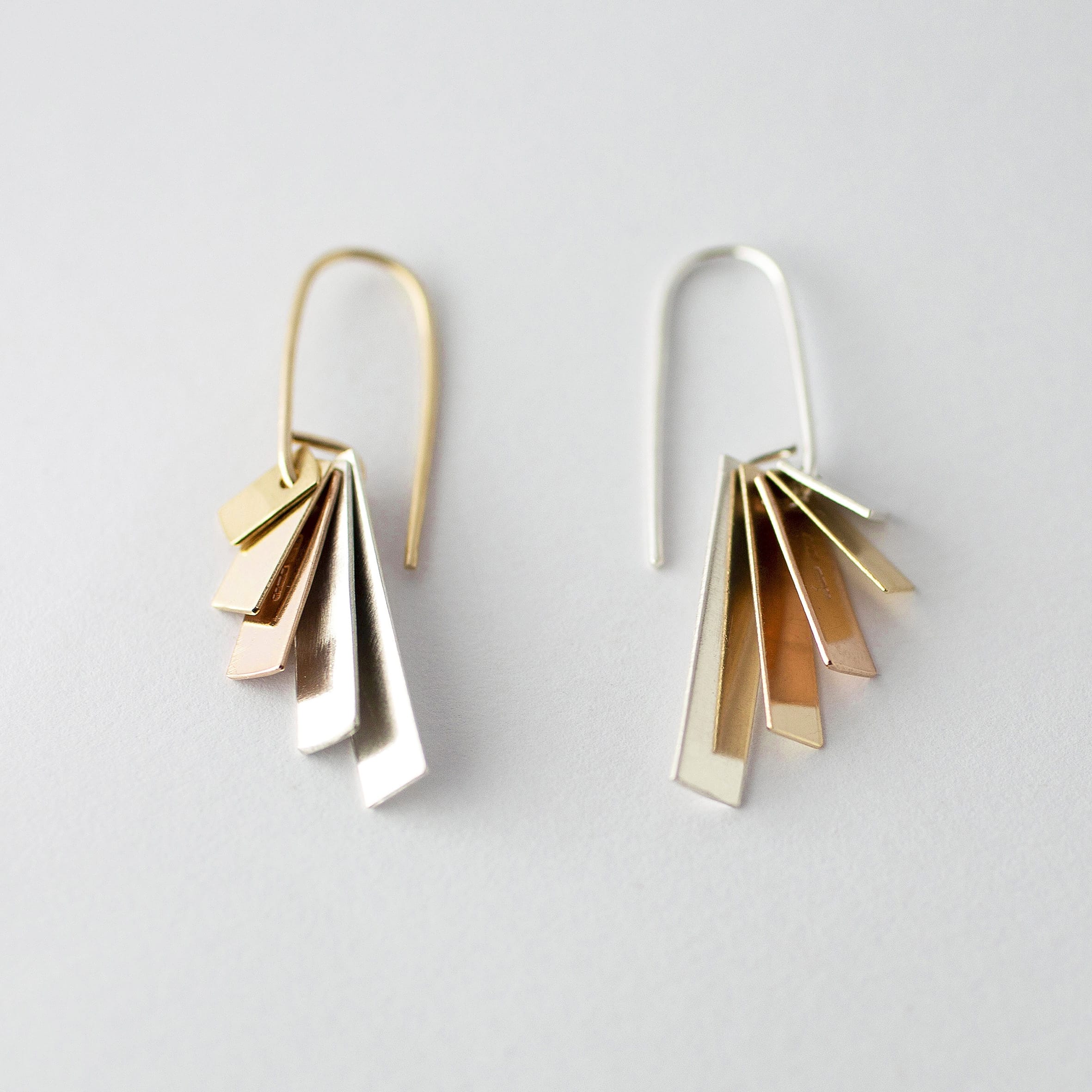 Earrings that comprise of layered rectangles in varying metals