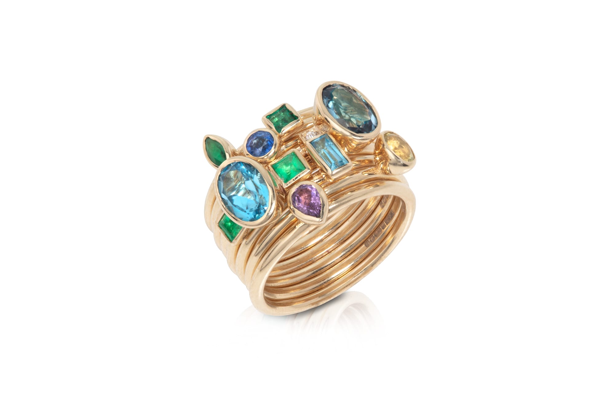 Gold ring, formed of multiple bands fused together and with different shaped and coloured gemstones banded together in a cluster