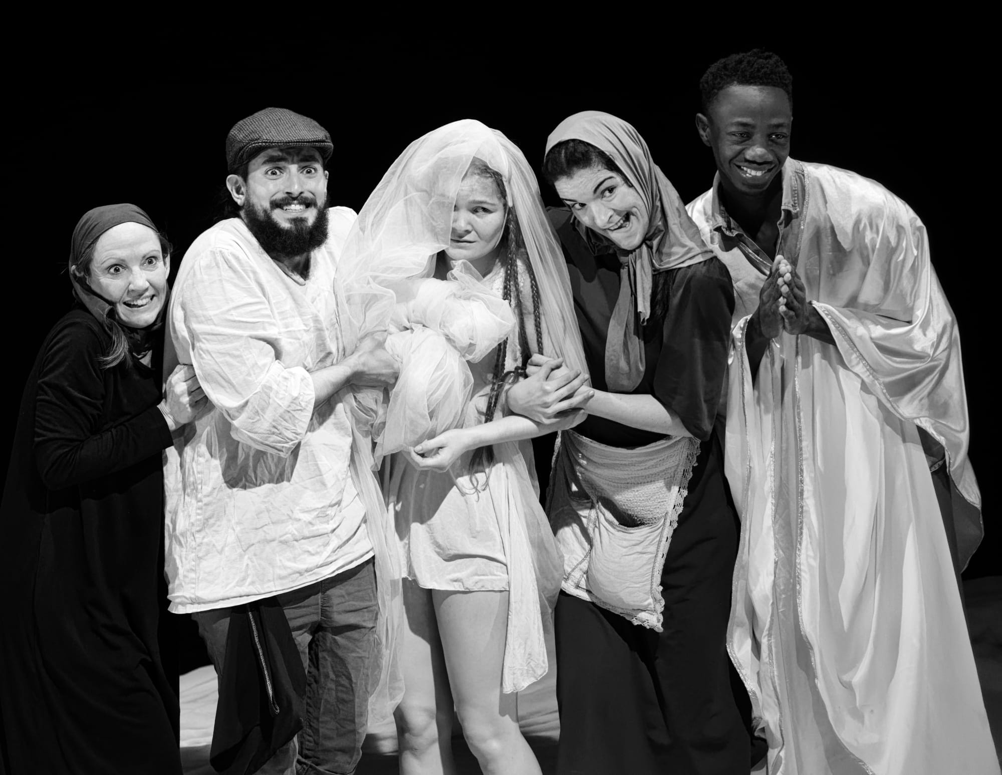 a black and white photo of a group of performers that seem to be a wedding picture