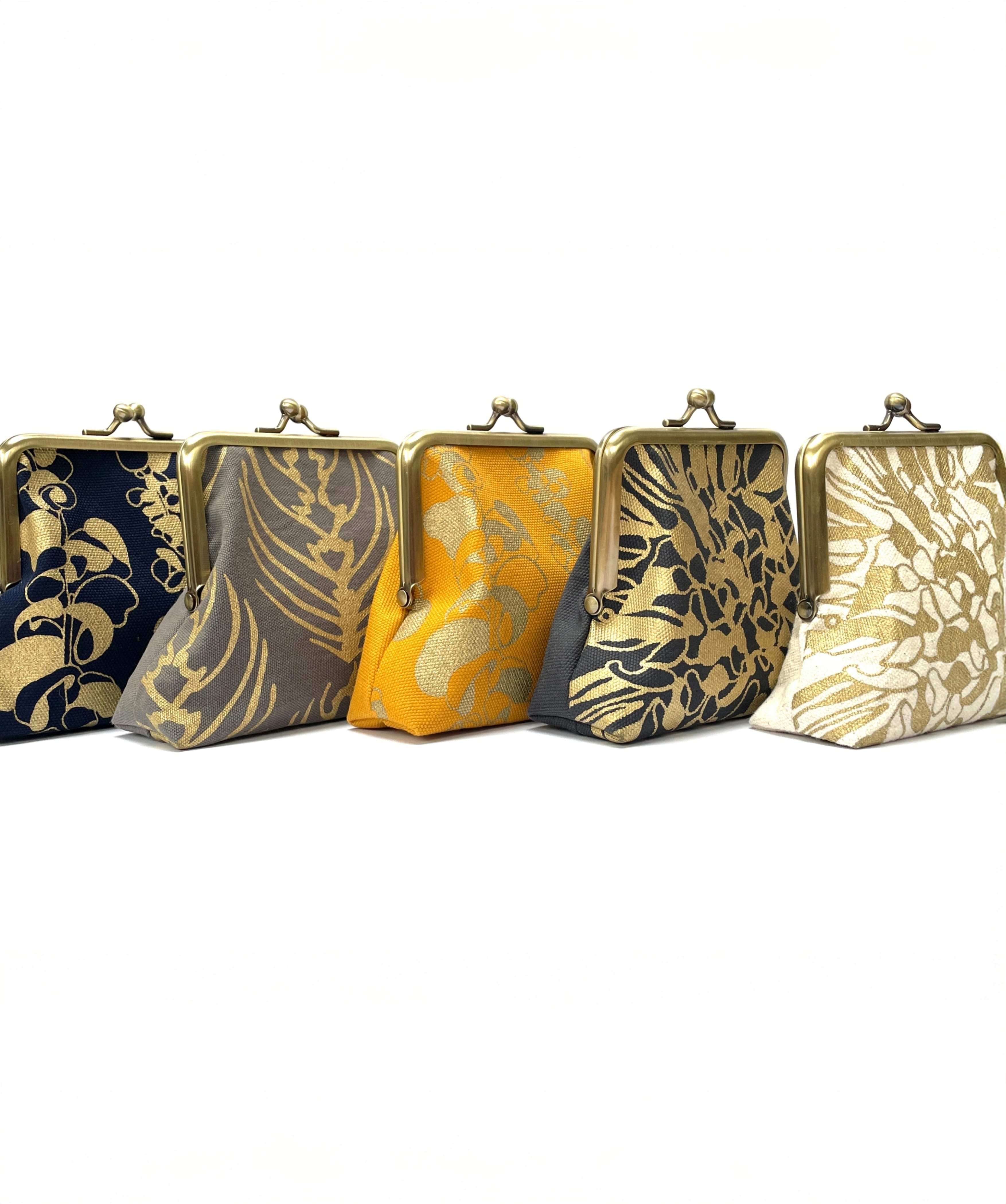 Purses with fabric embossed with intricate golden floral detailing.