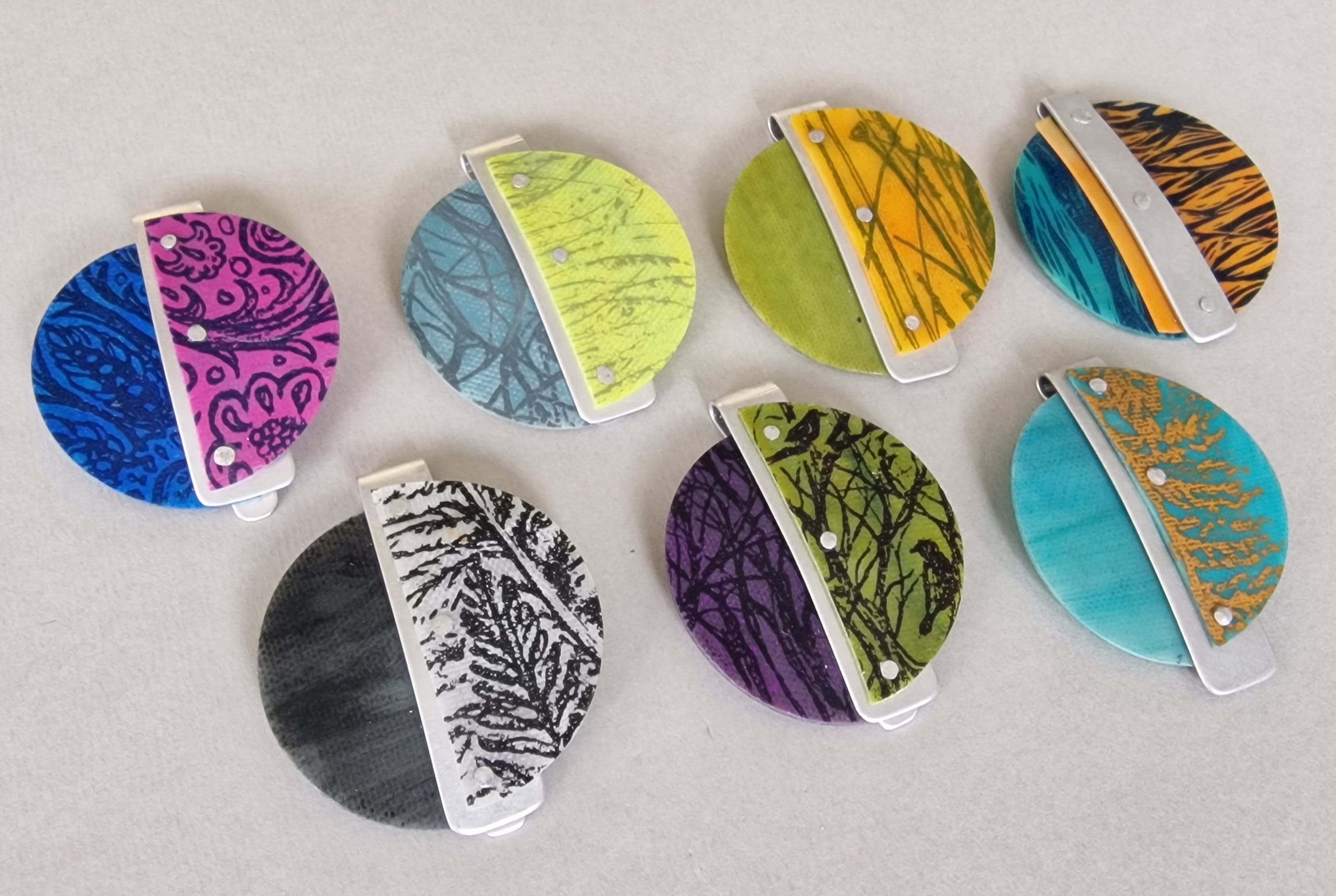 Vibrantly coloured and patterned earrings, split down the middle with a varying colour and pattern on each side.