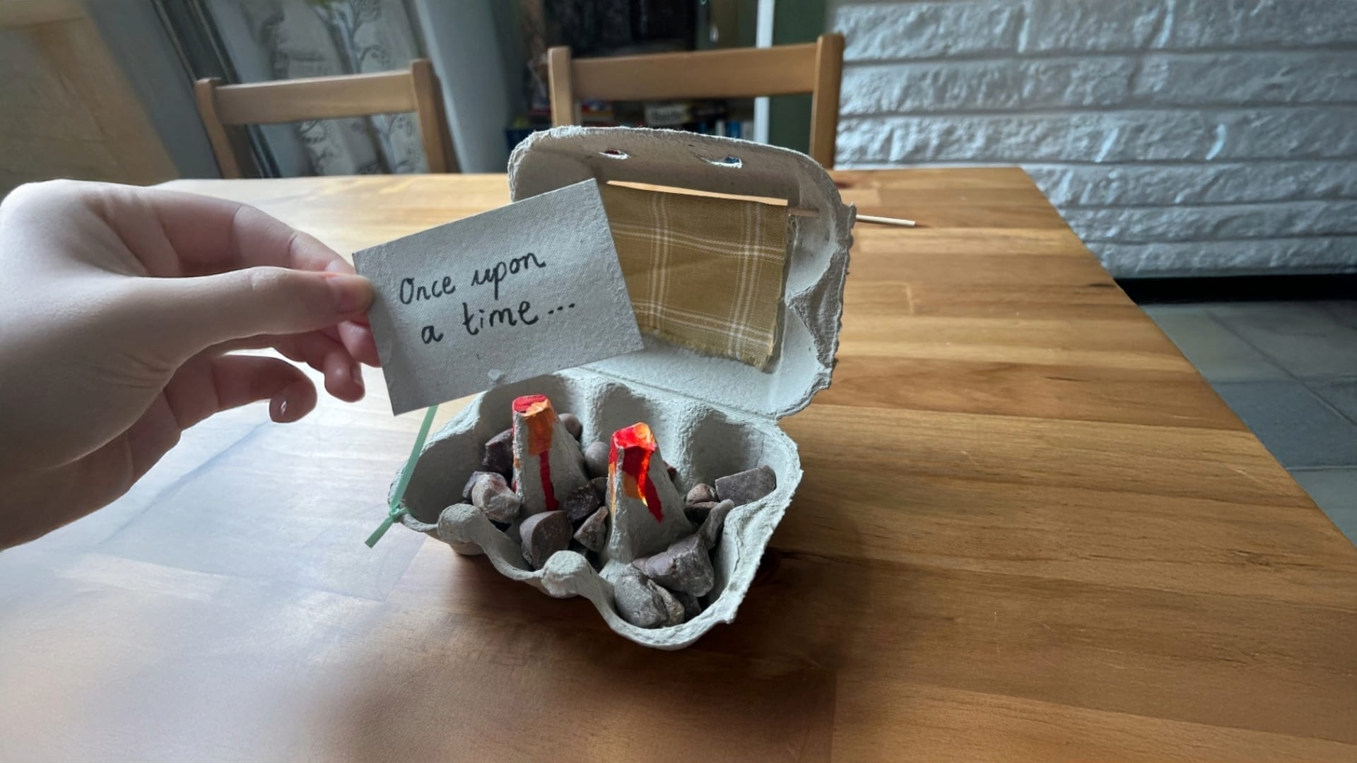 A cardboard egg box is turned into a mini theatre.