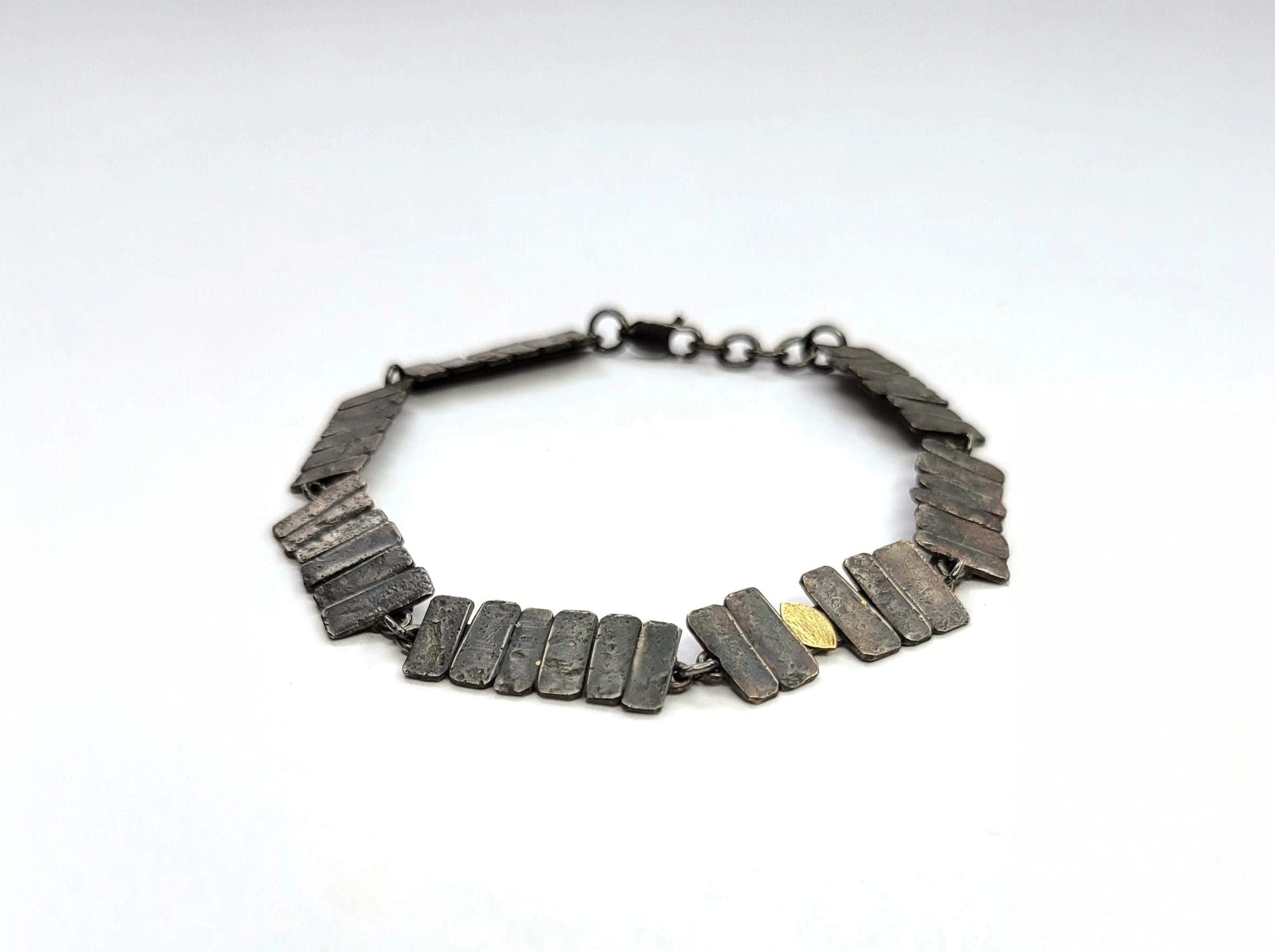 Necklace made of lots of dark coloured metal individual rectangles