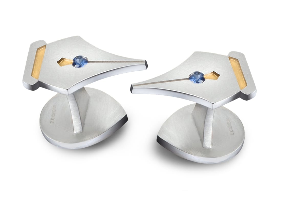 Two studs in the shape of a fountain pen tip with gemstone and golden detailing