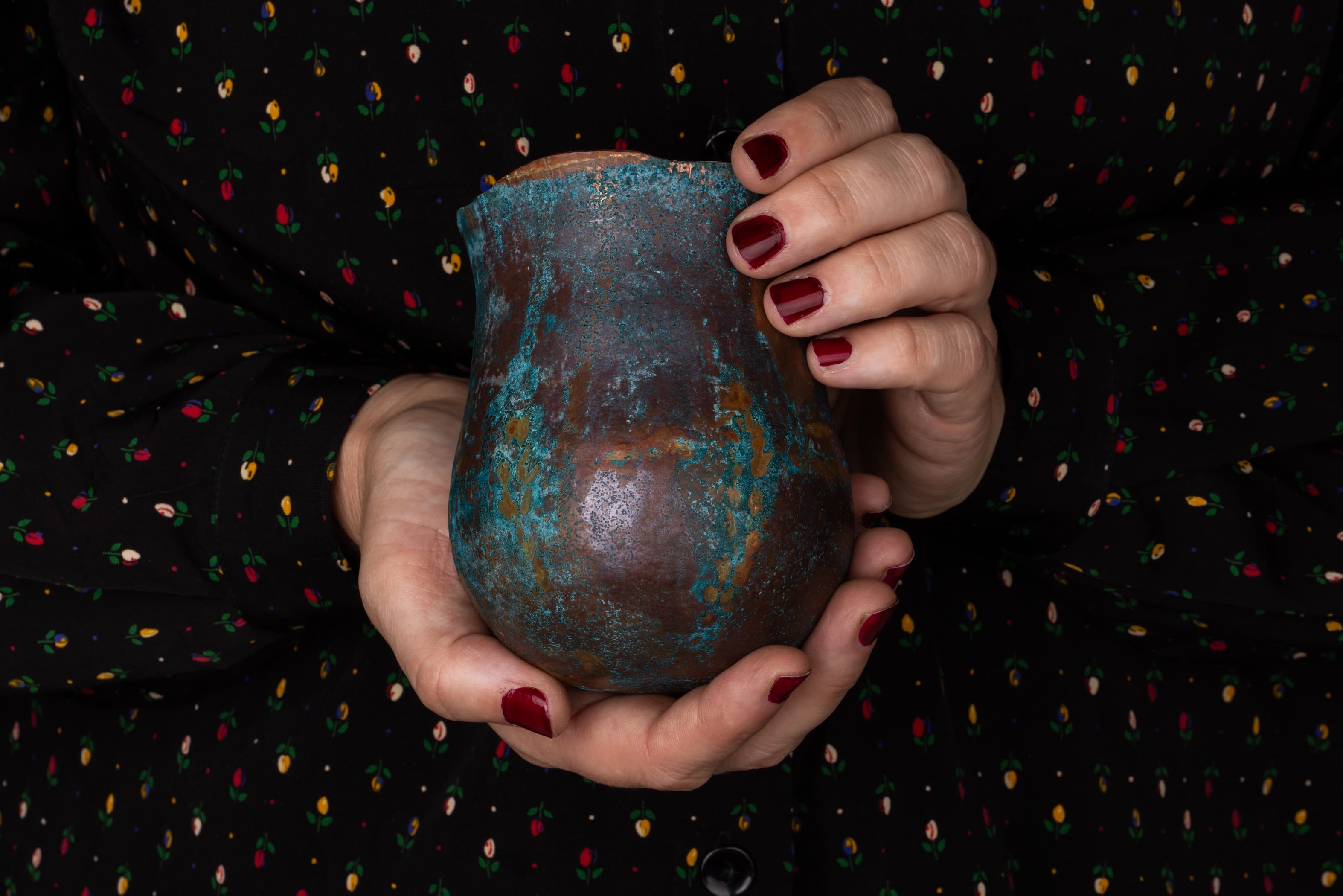 Beautiful vase being held with a dark colours