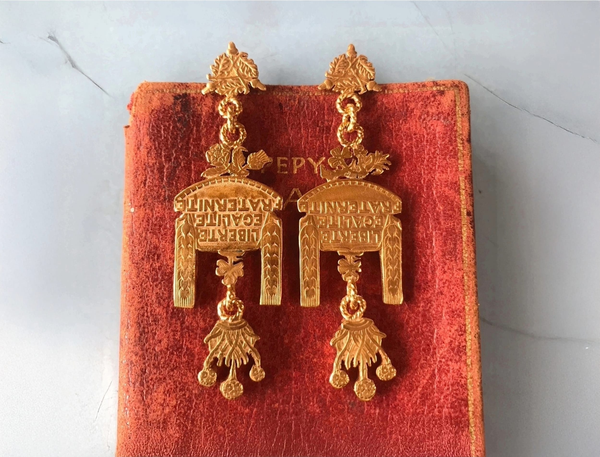 Vibrantly coloured and patterned earrings, split down the middle with a varying colour and pattern on each side.