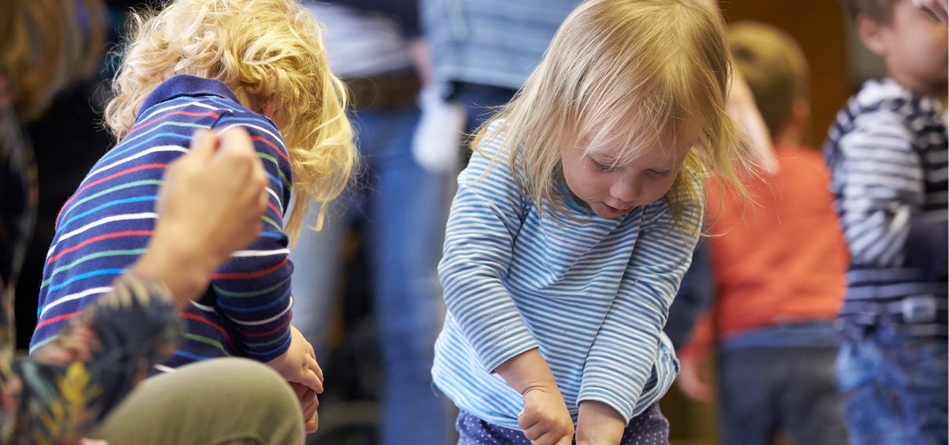 Two small children engrossed in sensory play.