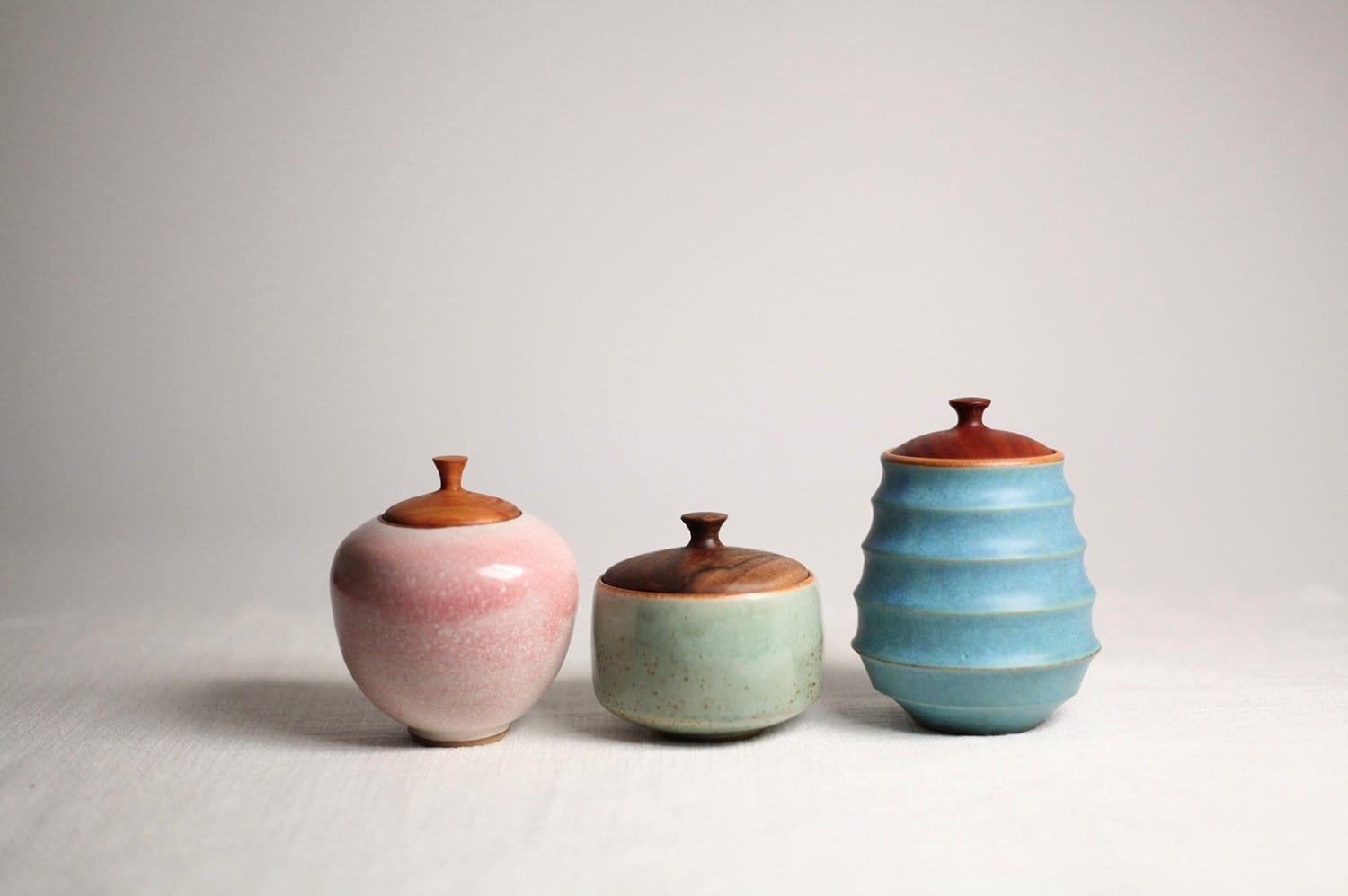 Three ceramics in soft pinks, blues and greens from maker 2 hungry bakers sit on a white surface