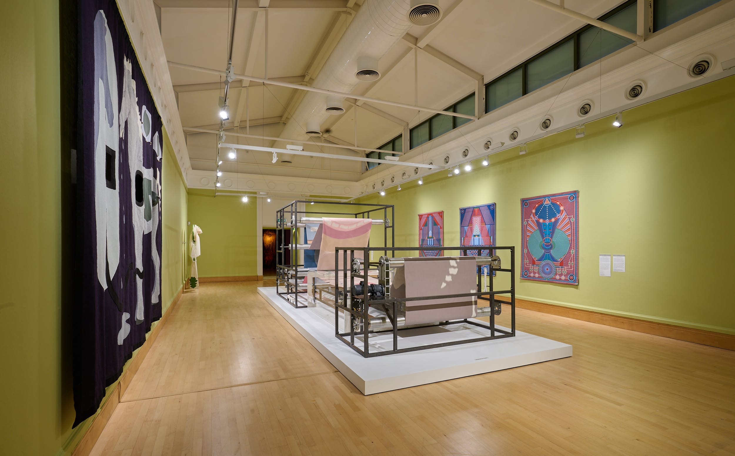 Image shows Holly Hendrys' installation 'Slacker' a giant printing press with a synthetic rubber printing ribbon ressembling an amalgamation of human organs, food, etc.